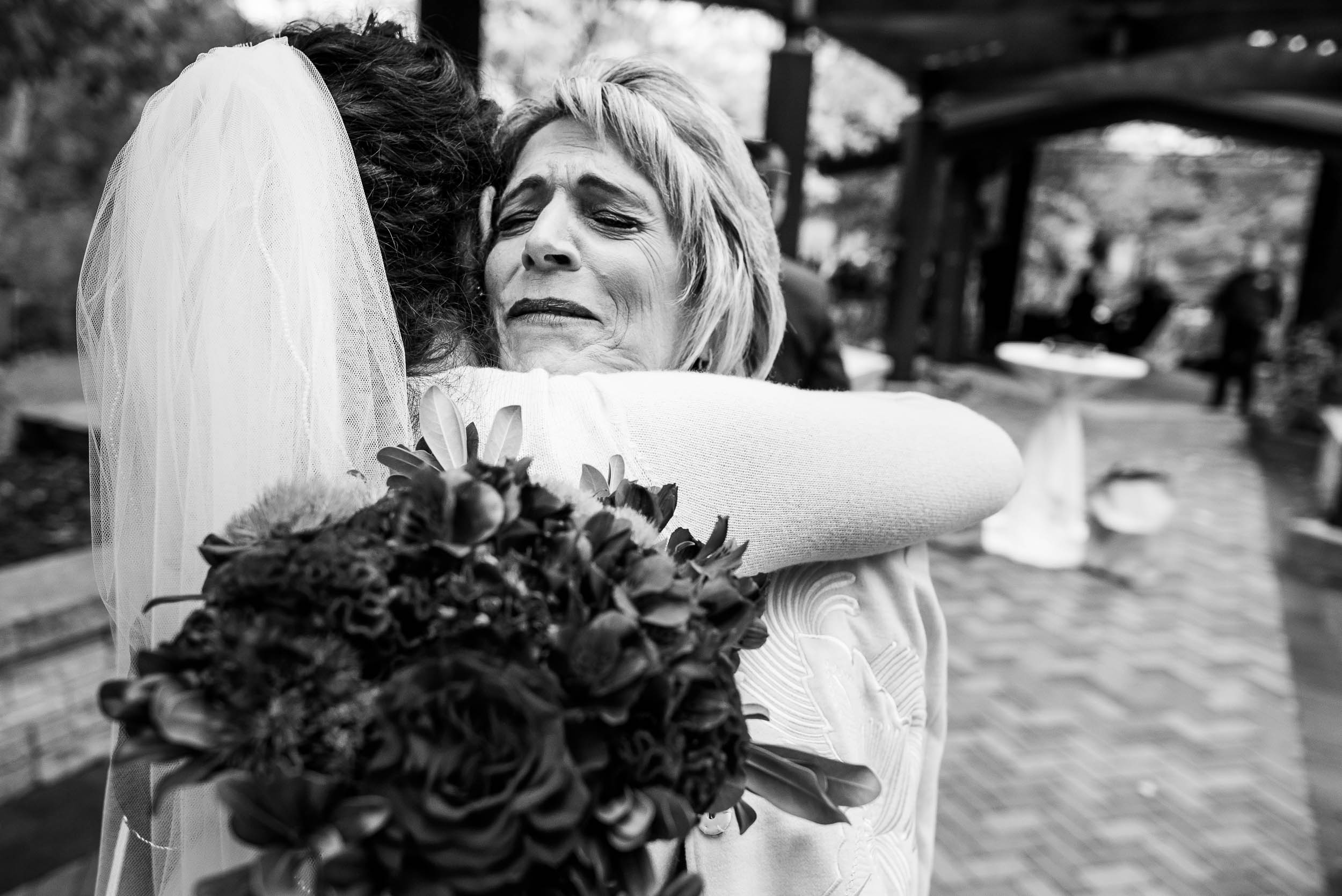 Mother and bride hug during an Independence Grove Chicago wedding.  