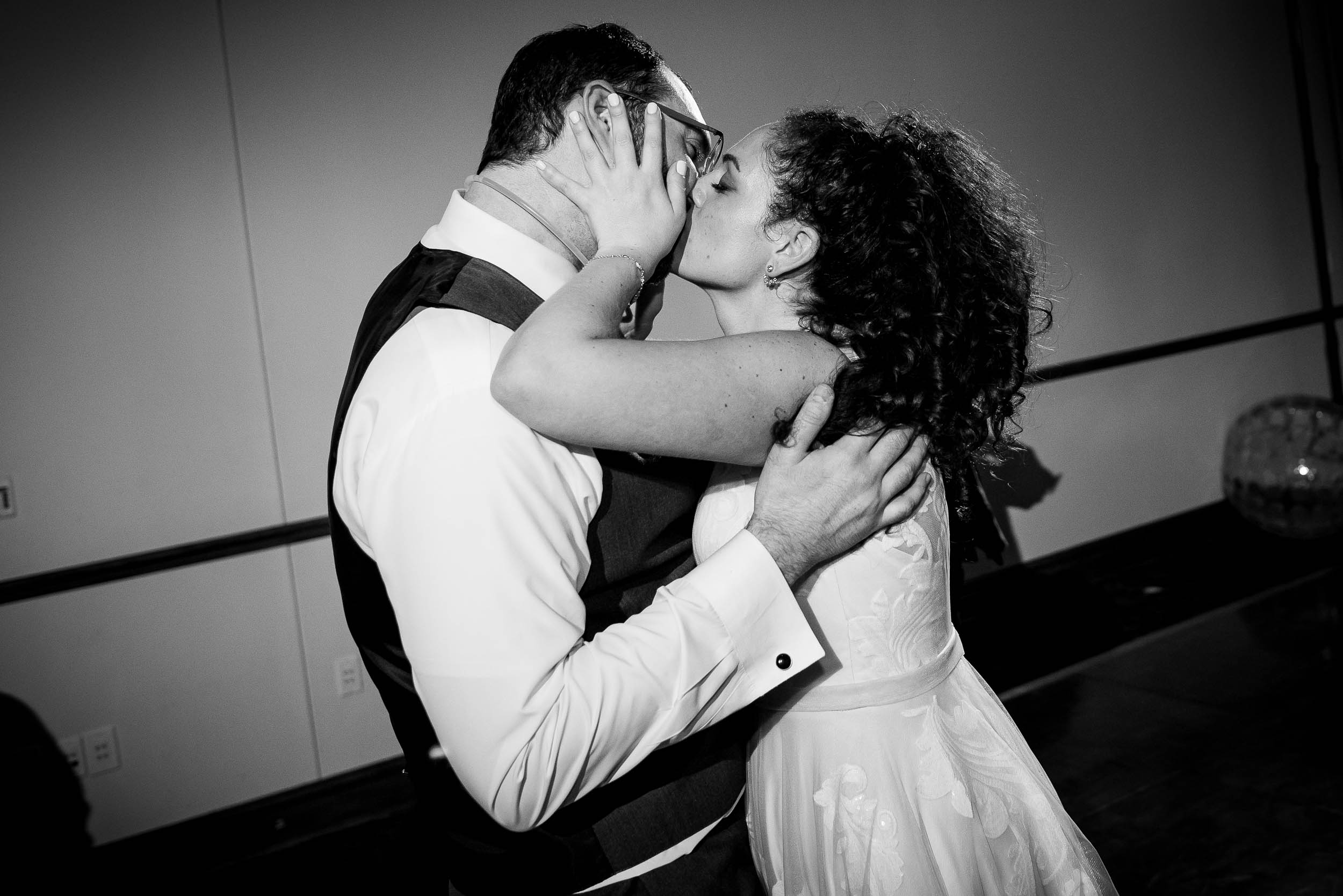 Bride and groom kiss on the dance floor during an Independence Grove Chicago wedding.  