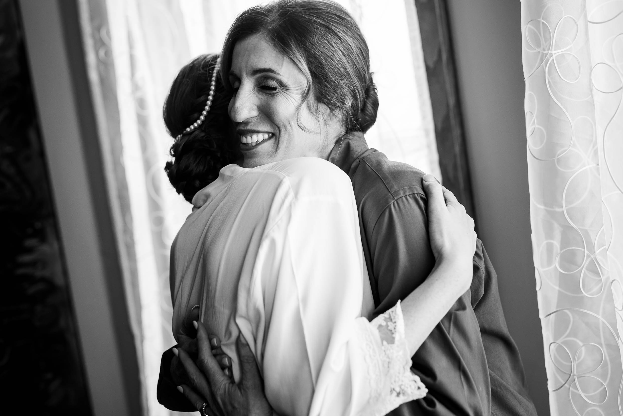 Mom and daughter hug during a Newberry Library Chicago wedding.