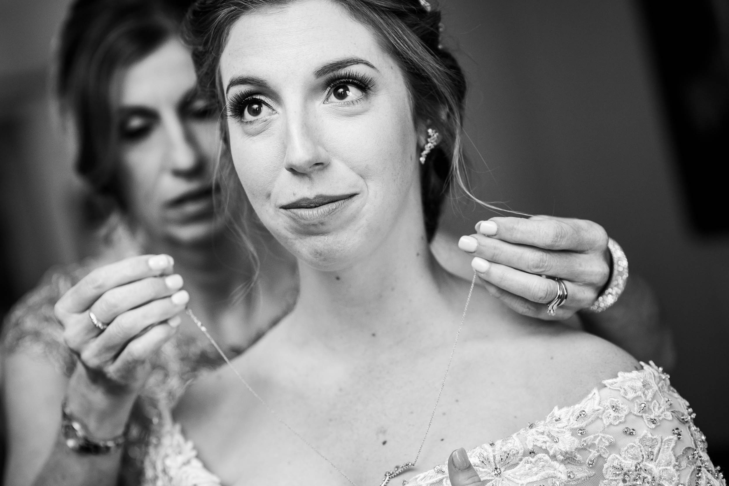 Mom helps the bride with her jewelry during a Newberry Library Chicago wedding.