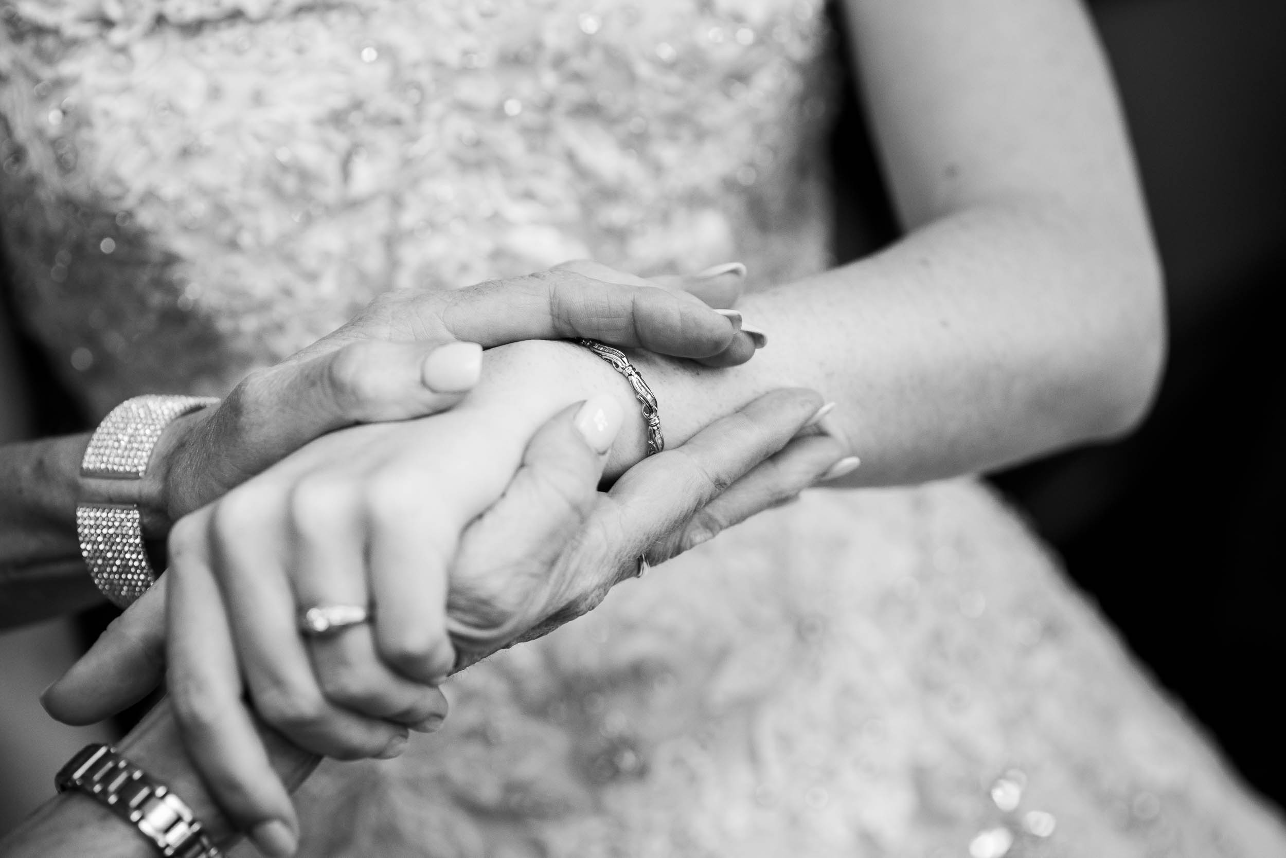 Mom helps the bride with her jewelry during a Newberry Library Chicago wedding.