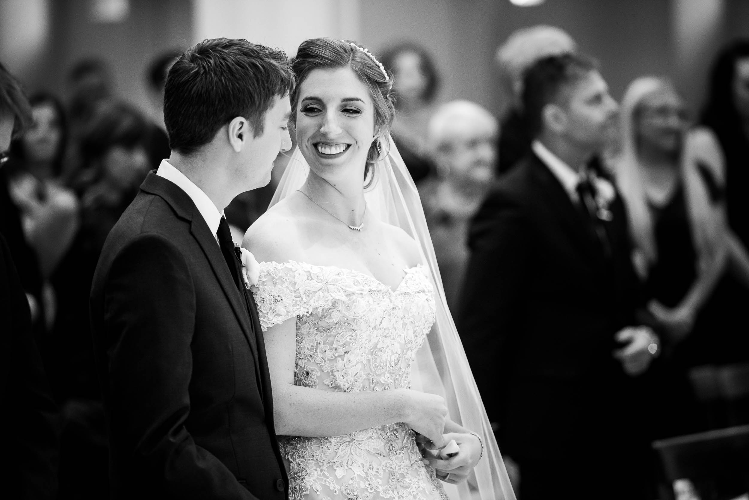 Brides gazes toward her groom during a wedding ceremony at Madonna Della Strada.