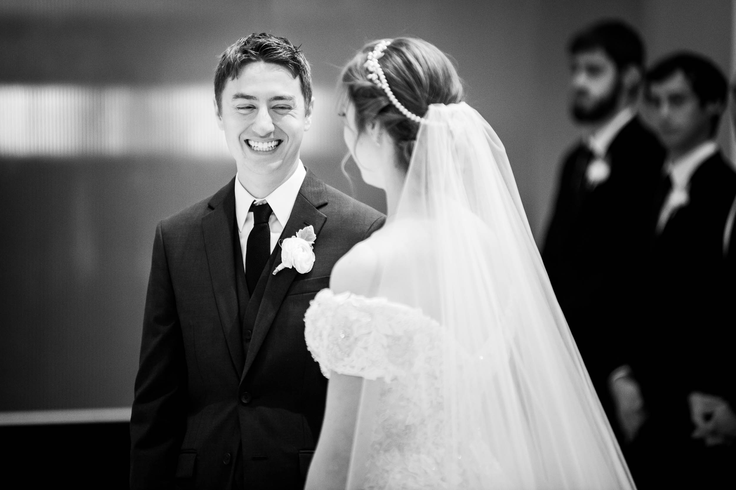 Groom laughs with the bride during a wedding ceremony at Madonna Della Strada.