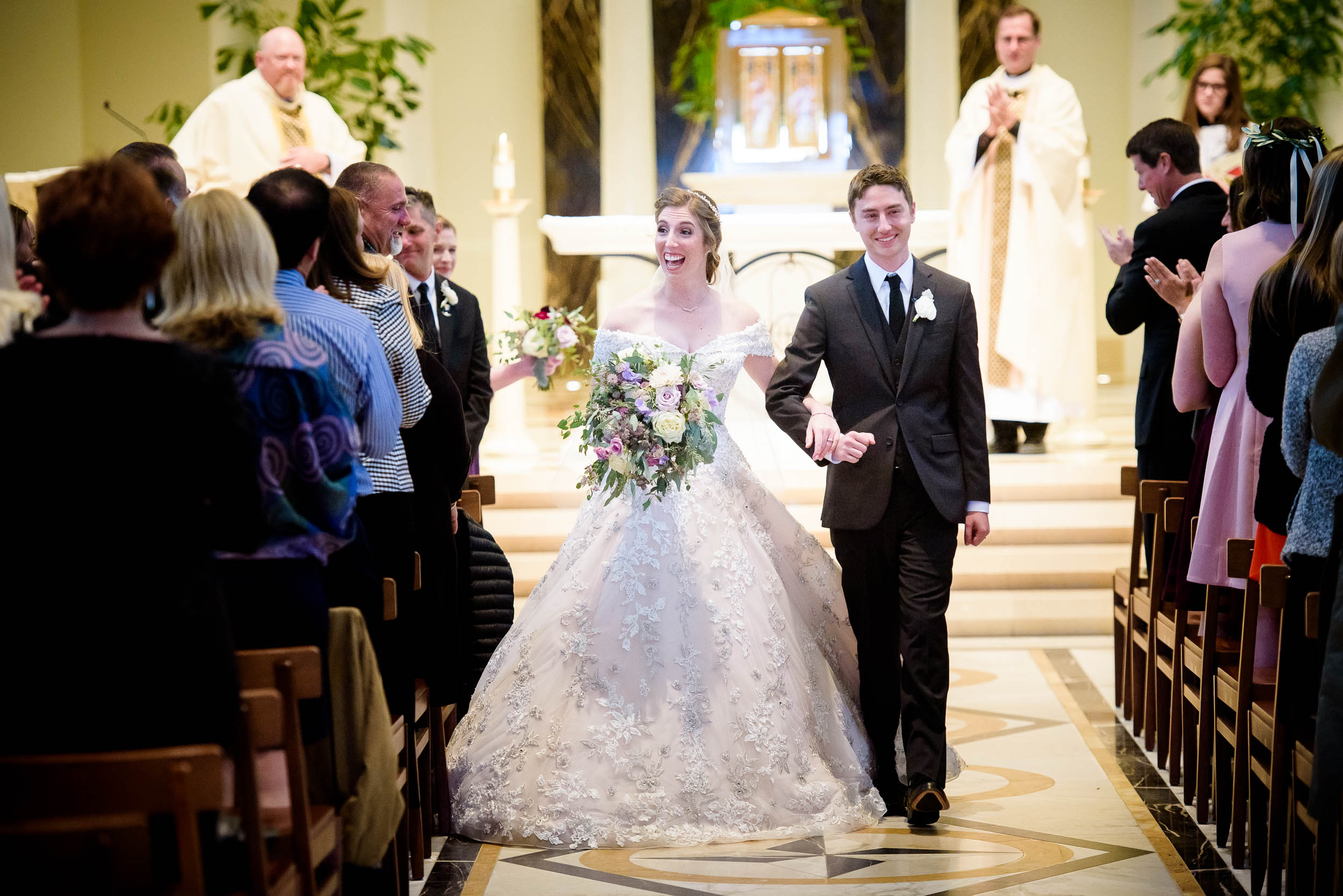 Bride and groom walk down the aisle during a wedding ceremony at Madonna Della Strada.