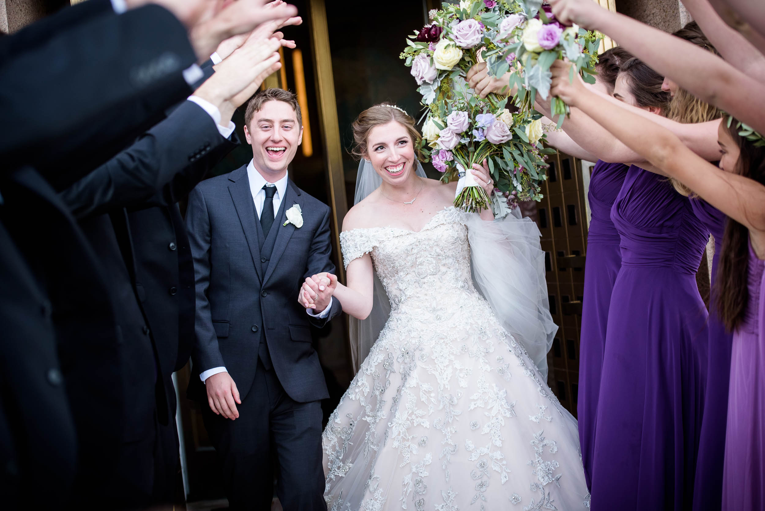 Bride and groom exit the church during a wedding ceremony at Madonna Della Strada.