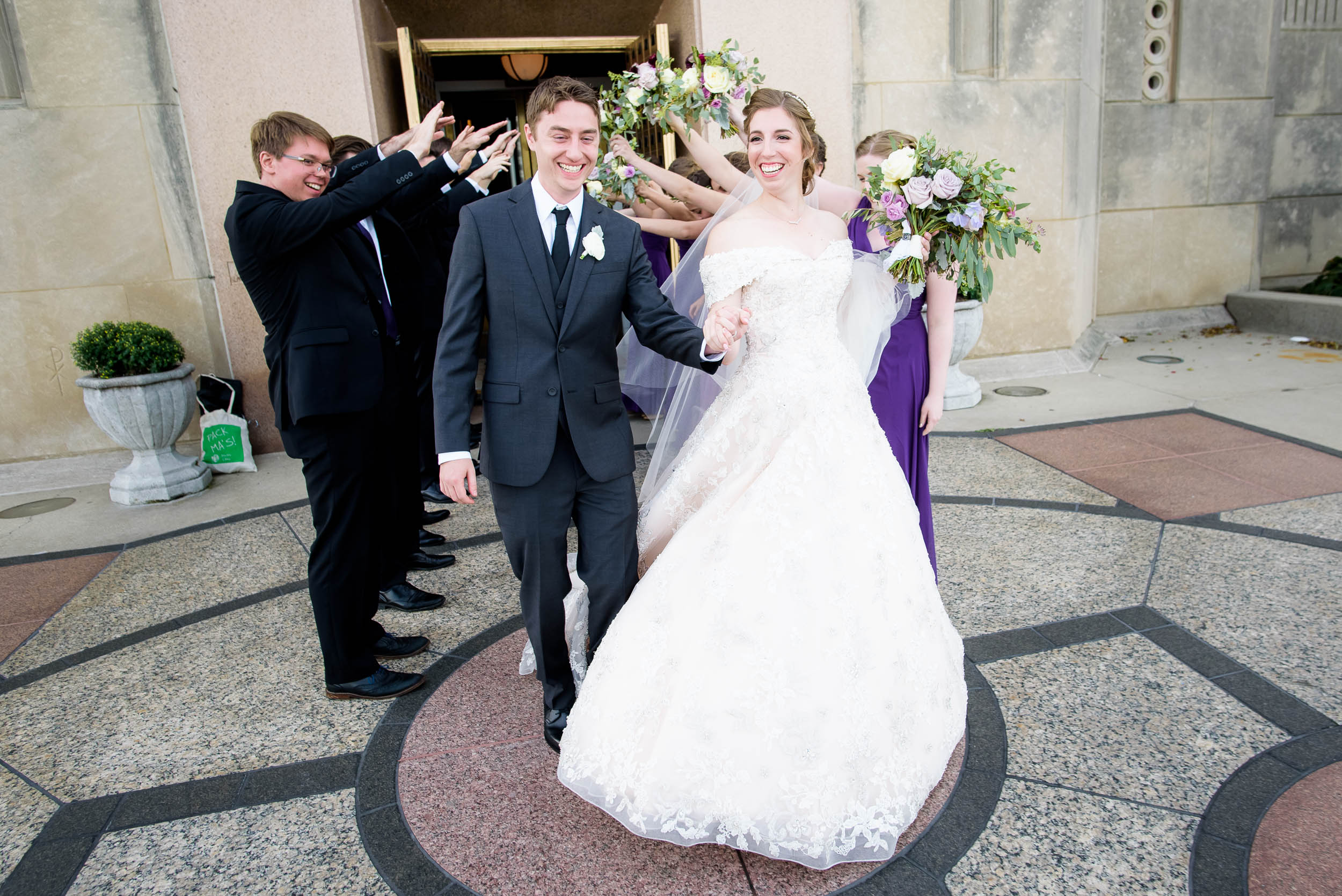 Bride and groom exit the church during a wedding ceremony at Madonna Della Strada.