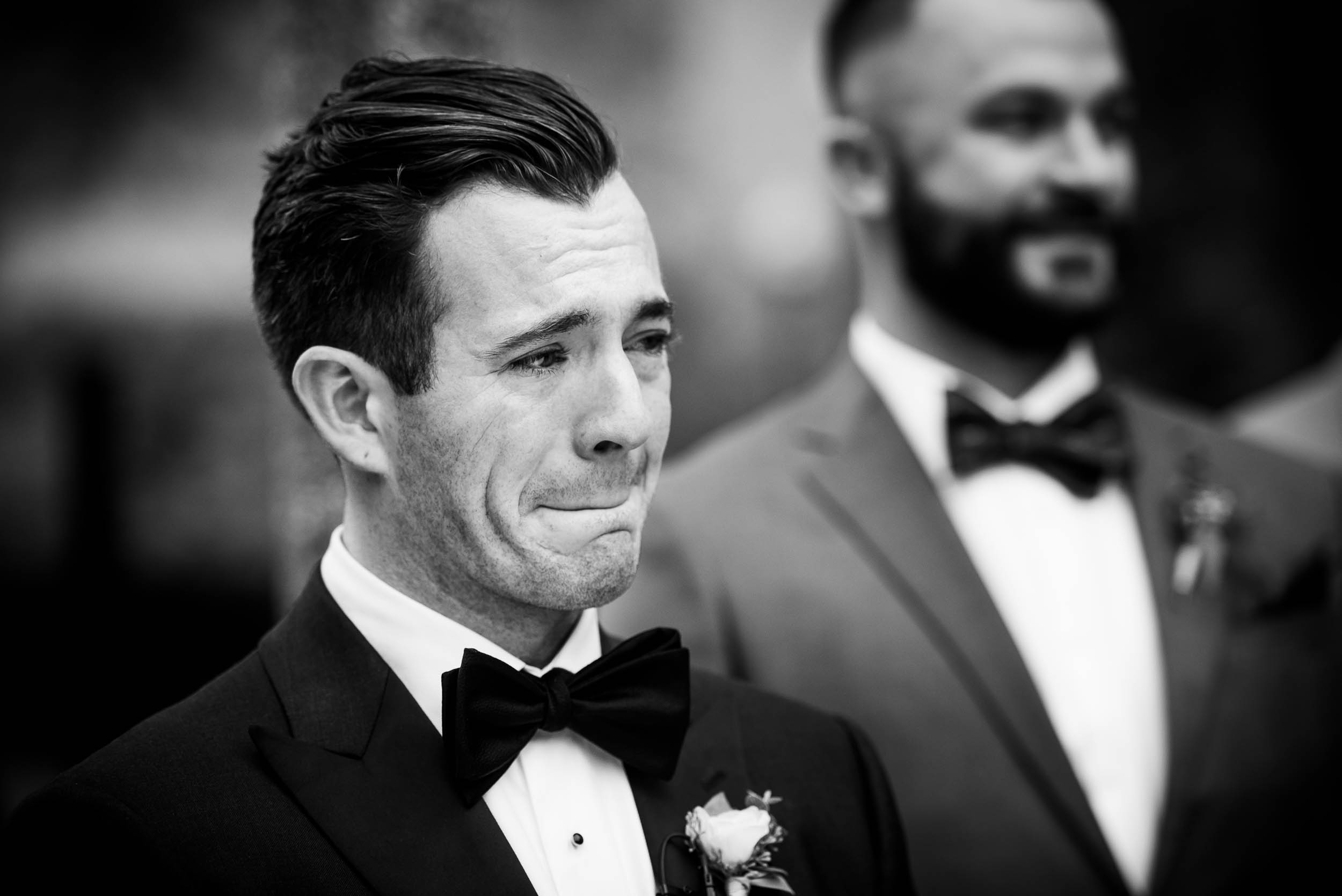 Groom reacts to his bride coming down the aisle during a Glessner House Chicago wedding.