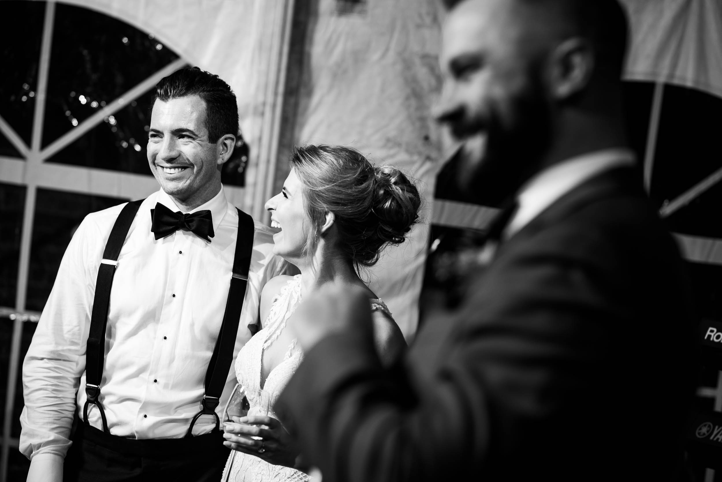 Bride and groom laugh to toasts during a Glessner House Chicago wedding reception.