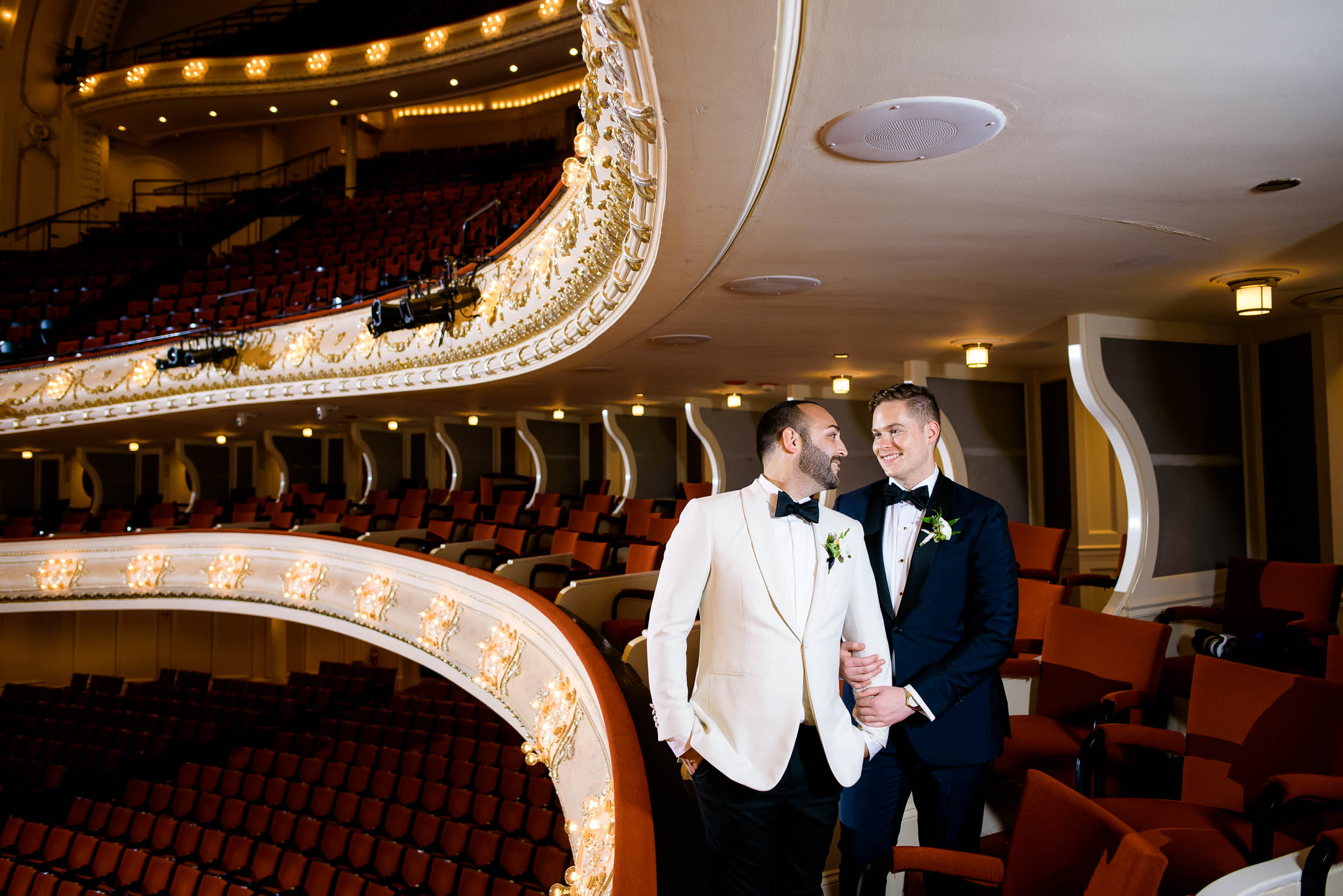 Grooms posing inside wedding venue for luxurious fall wedding at the Chicago Symphony Center captured by J. Brown Photography. See more wedding ideas at jbrownphotography.com!