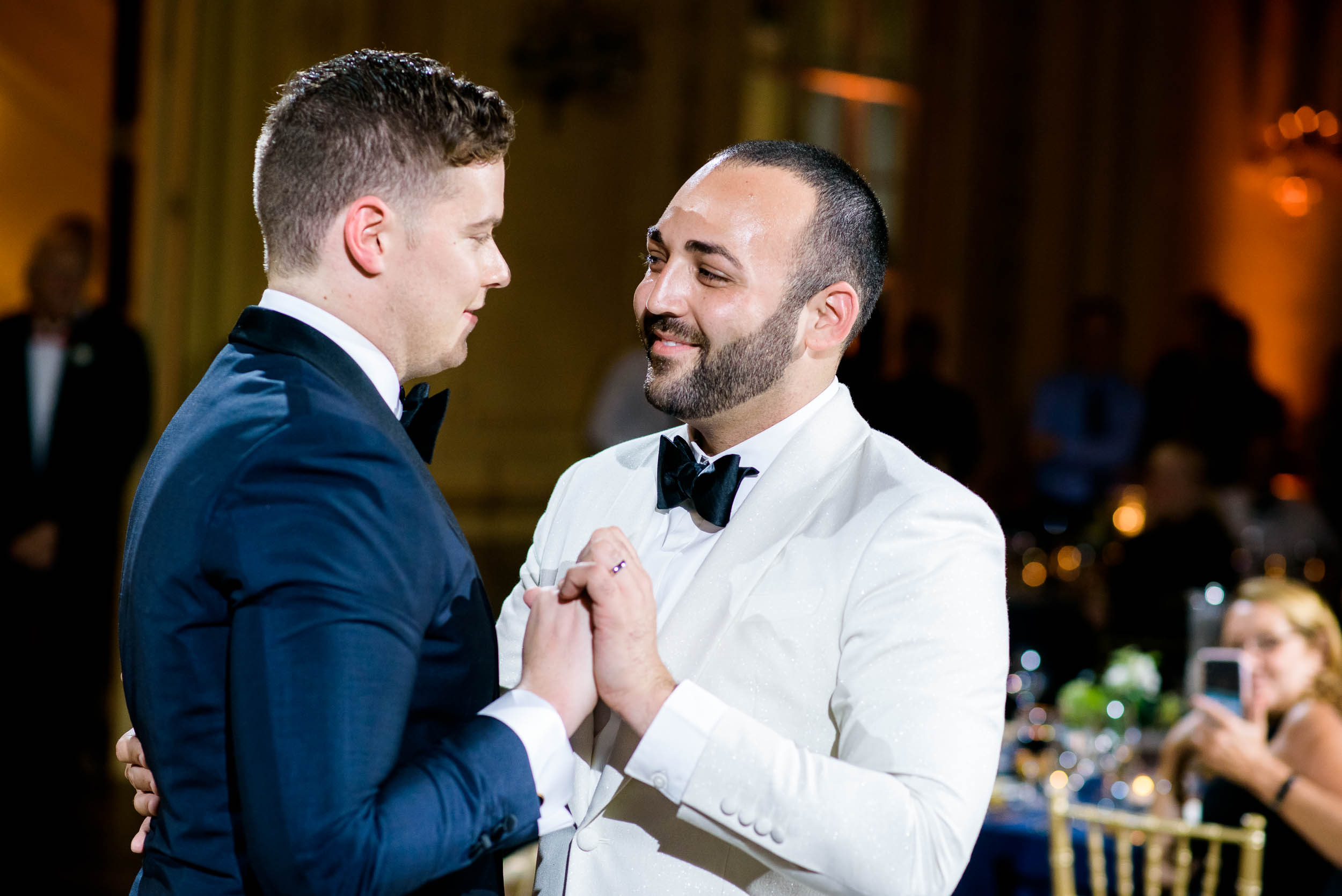 Grooms sharing a first dance for luxurious fall wedding at the Chicago Symphony Center captured by J. Brown Photography. See more wedding ideas at jbrownphotography.com!