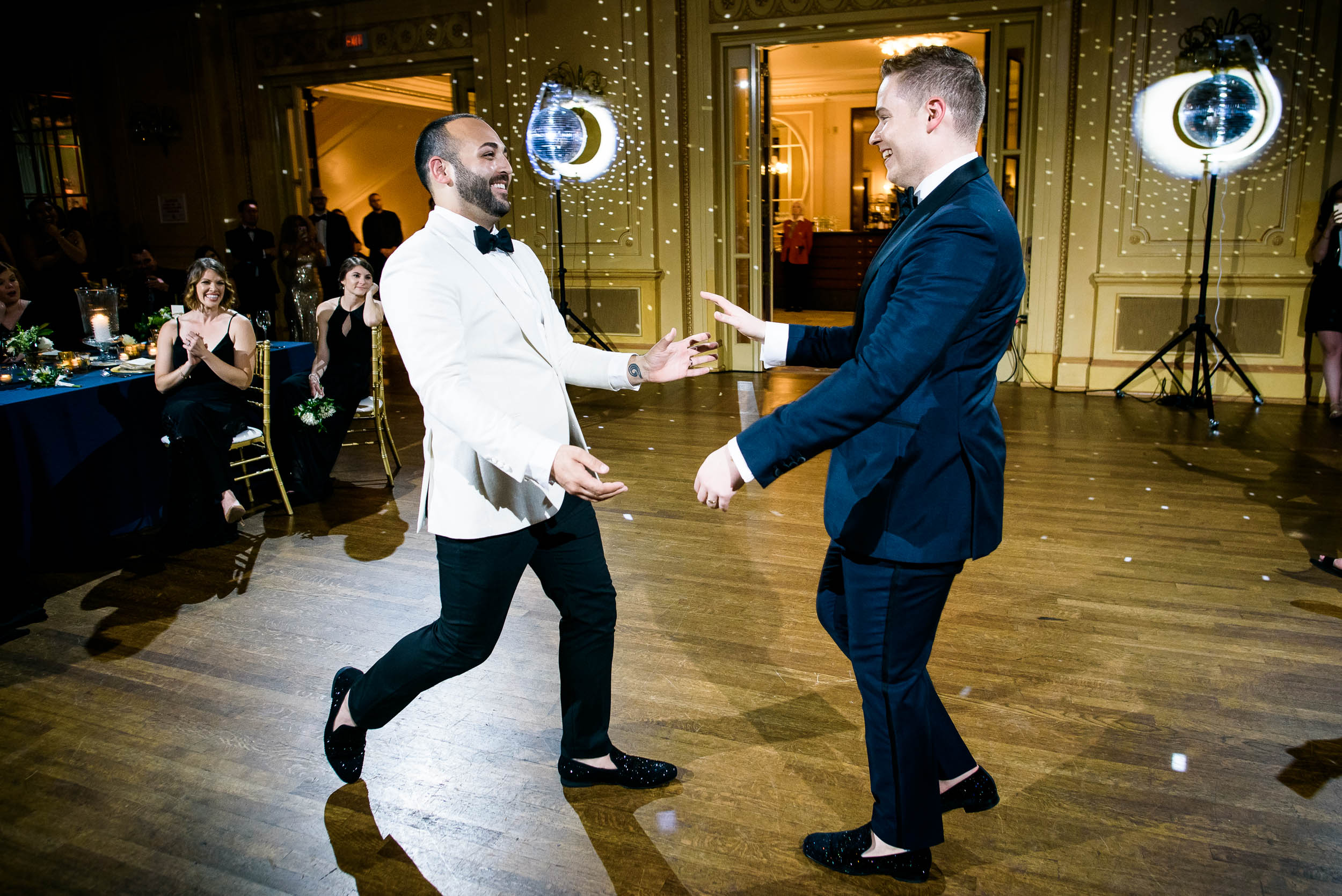 Grooms dancing at wedding reception for luxurious fall wedding at the Chicago Symphony Center captured by J. Brown Photography. See more wedding ideas at jbrownphotography.com!