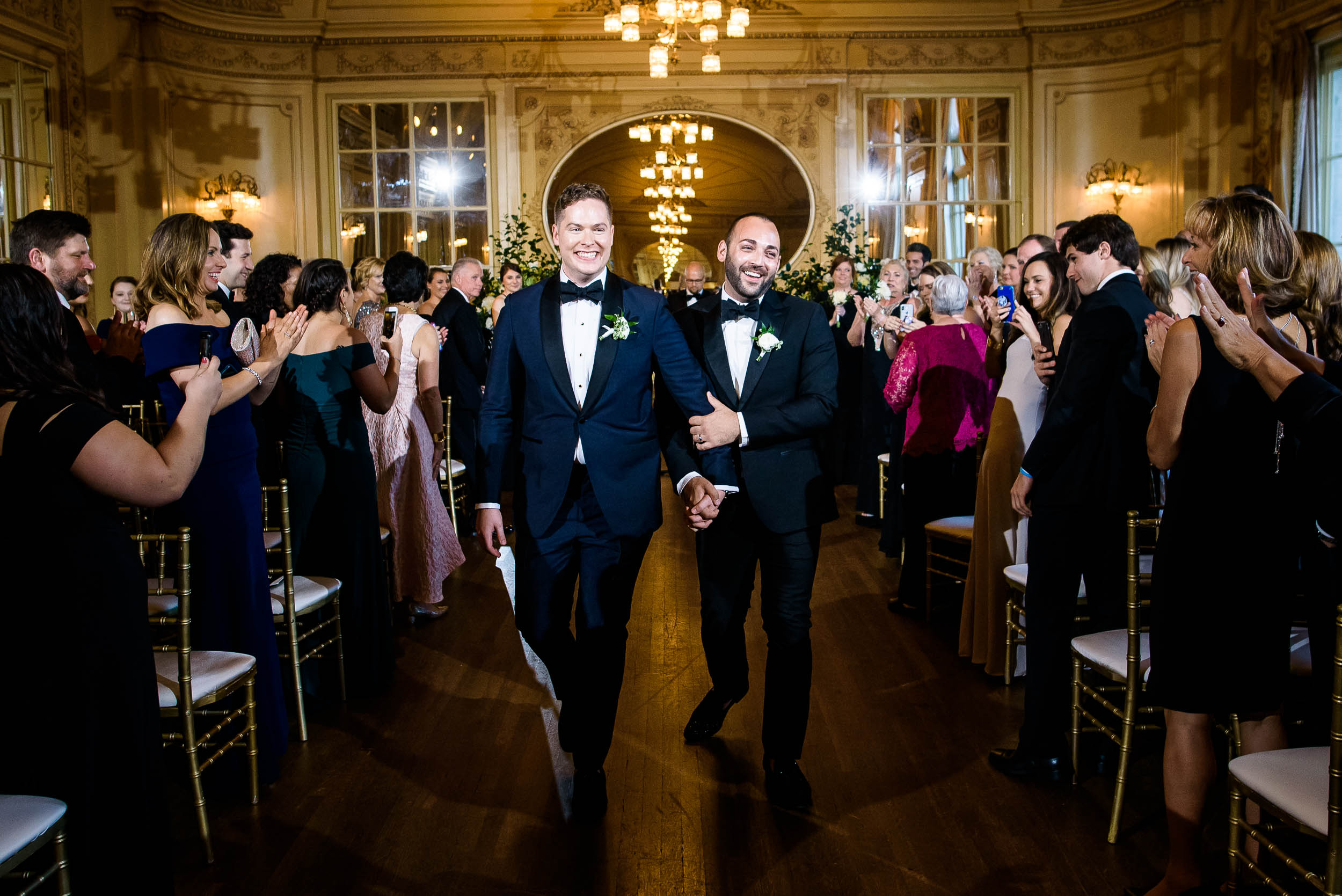 Grooms exiting wedding ceremony for luxurious fall wedding at the Chicago Symphony Center captured by J. Brown Photography. See more wedding ideas at jbrownphotography.com!