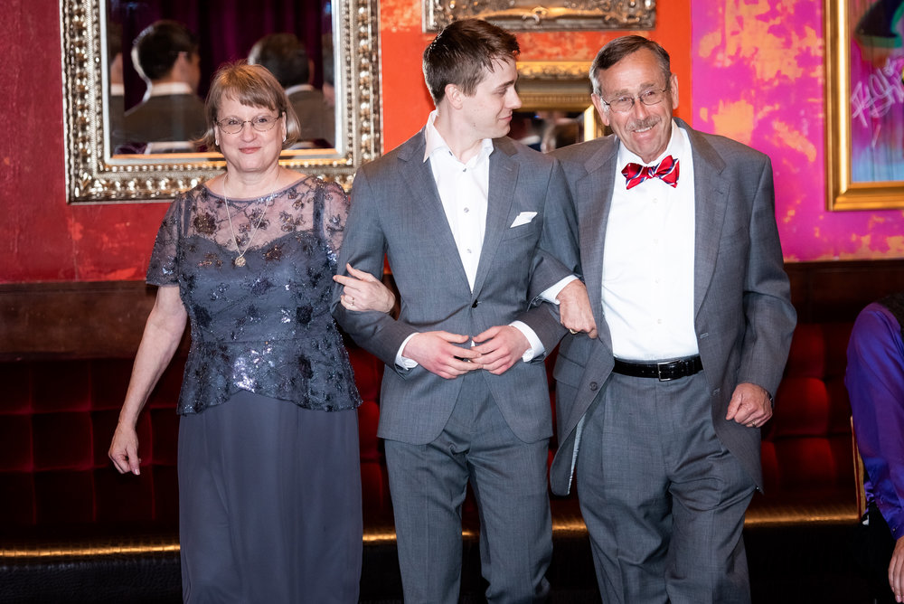 Groom walking into wedding ceremony with parents: Carnivale Chicago wedding captured by J Brown Photography