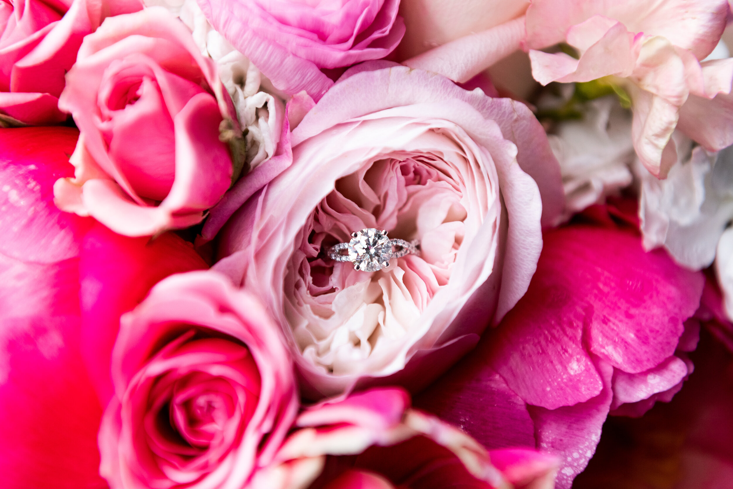 Wedding ring sitting in pink wedding flowers: Loews Chicago Hotel Wedding captured by J. Brown Photography