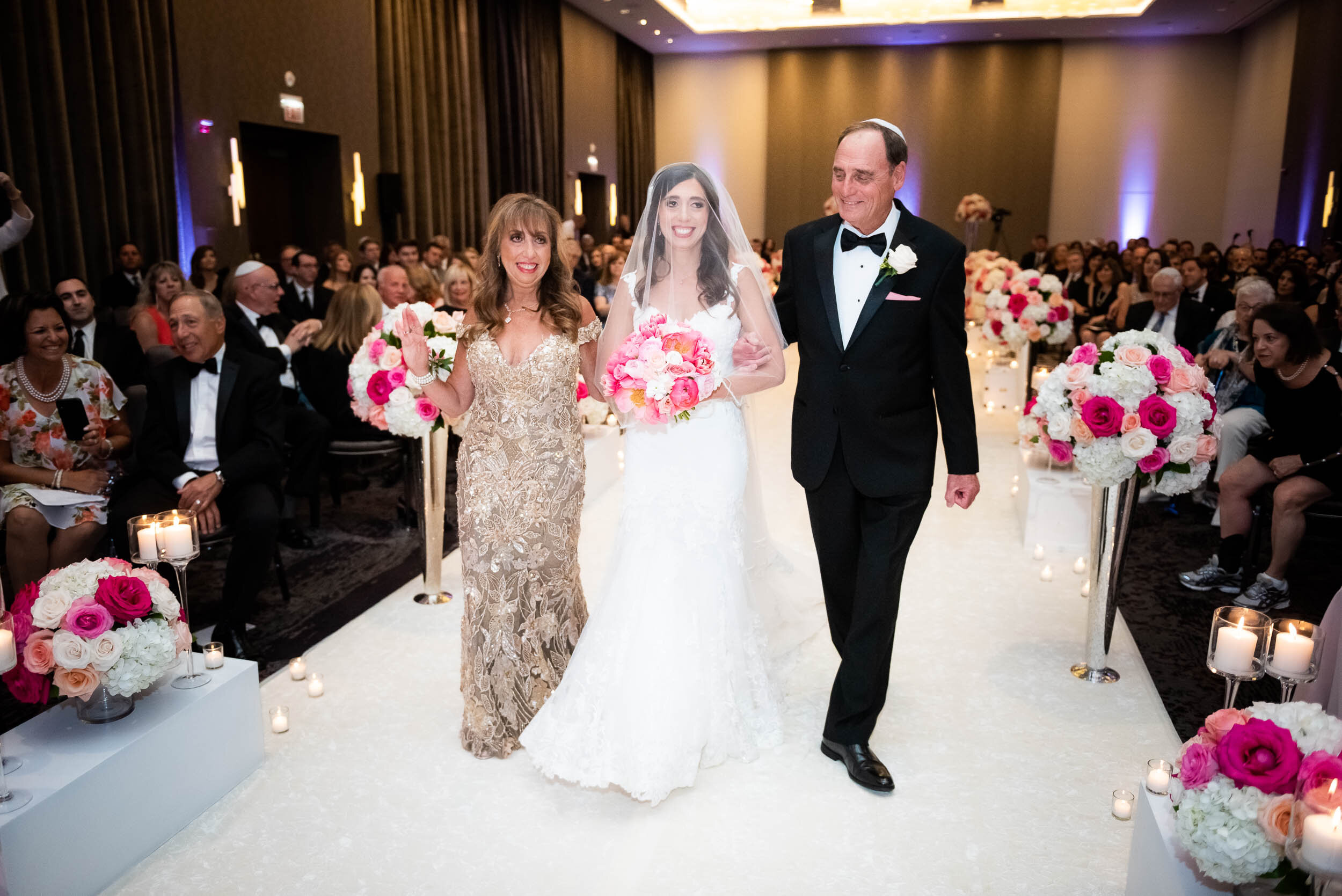 Bride walking down the aisle with parents: Loews Chicago Hotel Wedding captured by J. Brown Photography