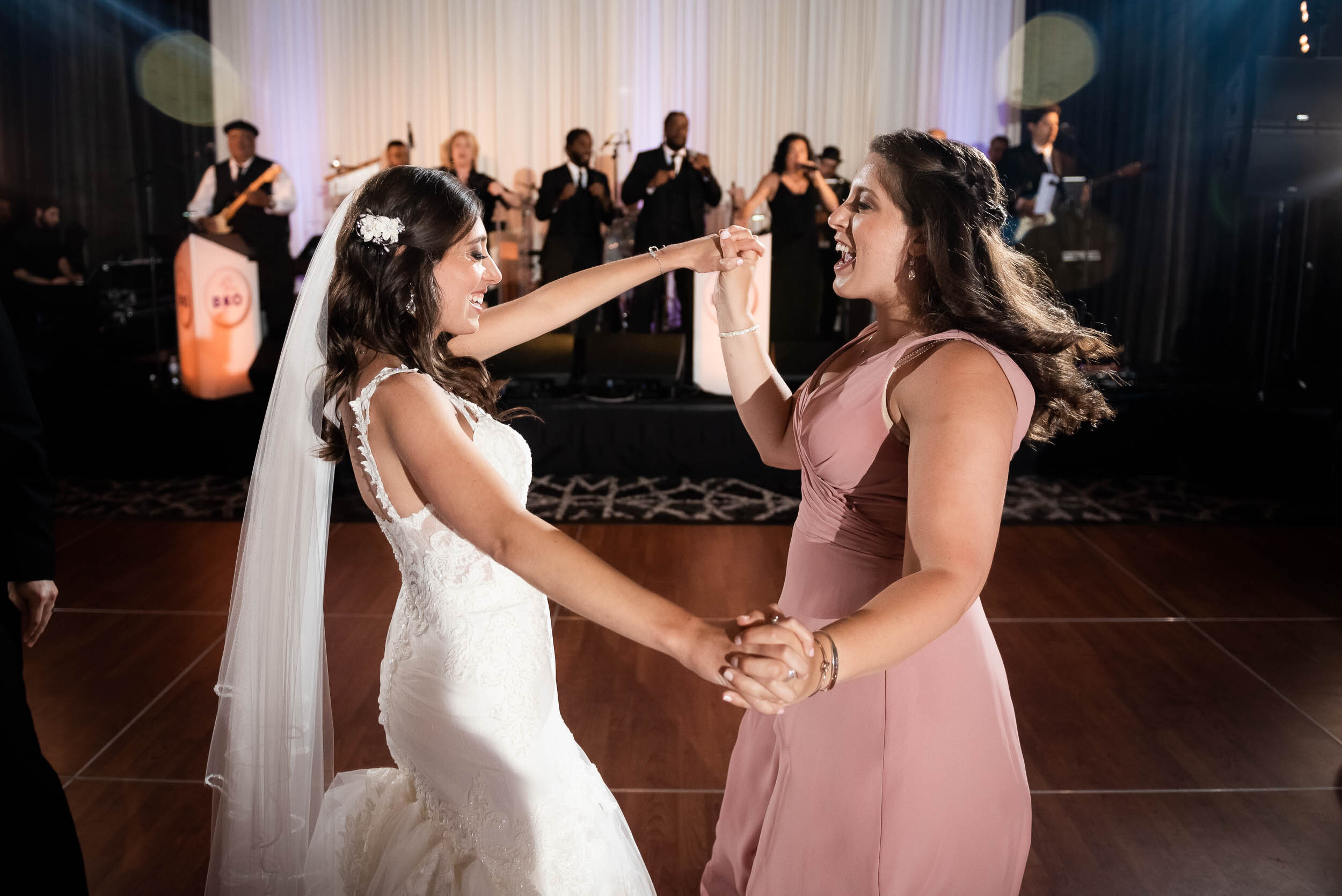 Bride and bridesmaid dancing: Loews Chicago Hotel Wedding captured by J. Brown Photography