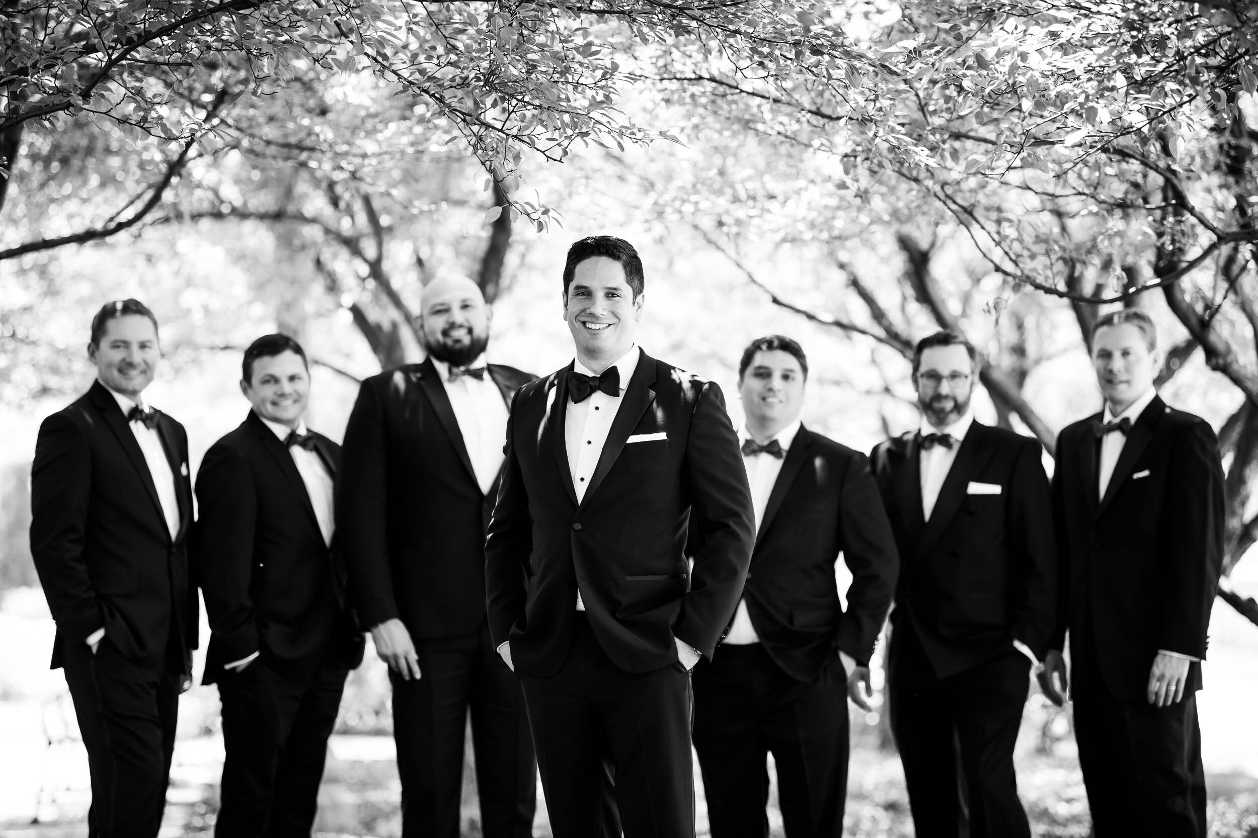 Black and white grooms and groomsmen photography: Carnivale Chicago Wedding captured by J. Brown Photography