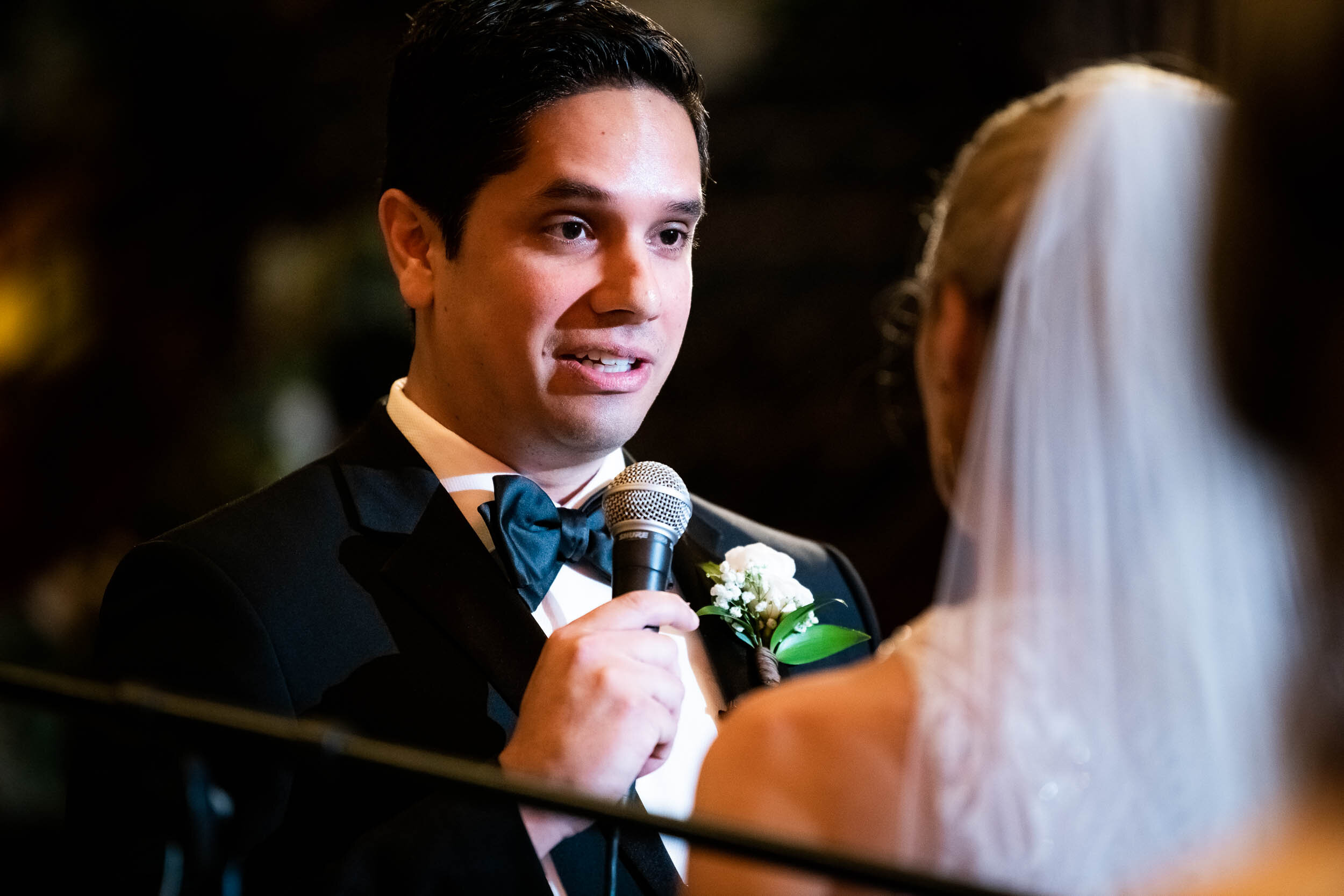 Groom sharing vows during wedding ceremony: Carnivale Chicago Wedding captured by J. Brown Photography
