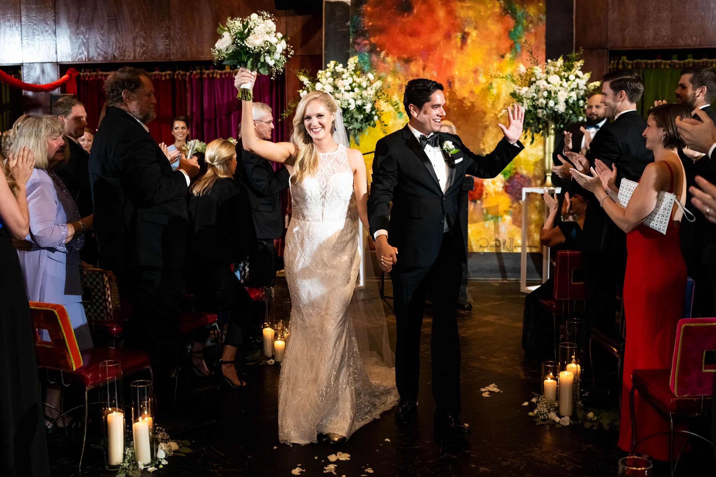 Bride and groom exiting wedding ceremony: Carnivale Chicago Wedding captured by J. Brown Photography