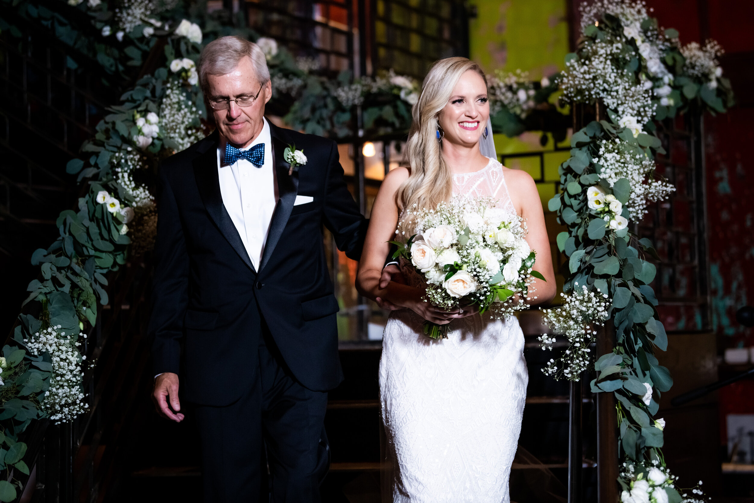 Bride escorted by parents down the aisle: Carnivale Chicago Wedding captured by J. Brown Photography