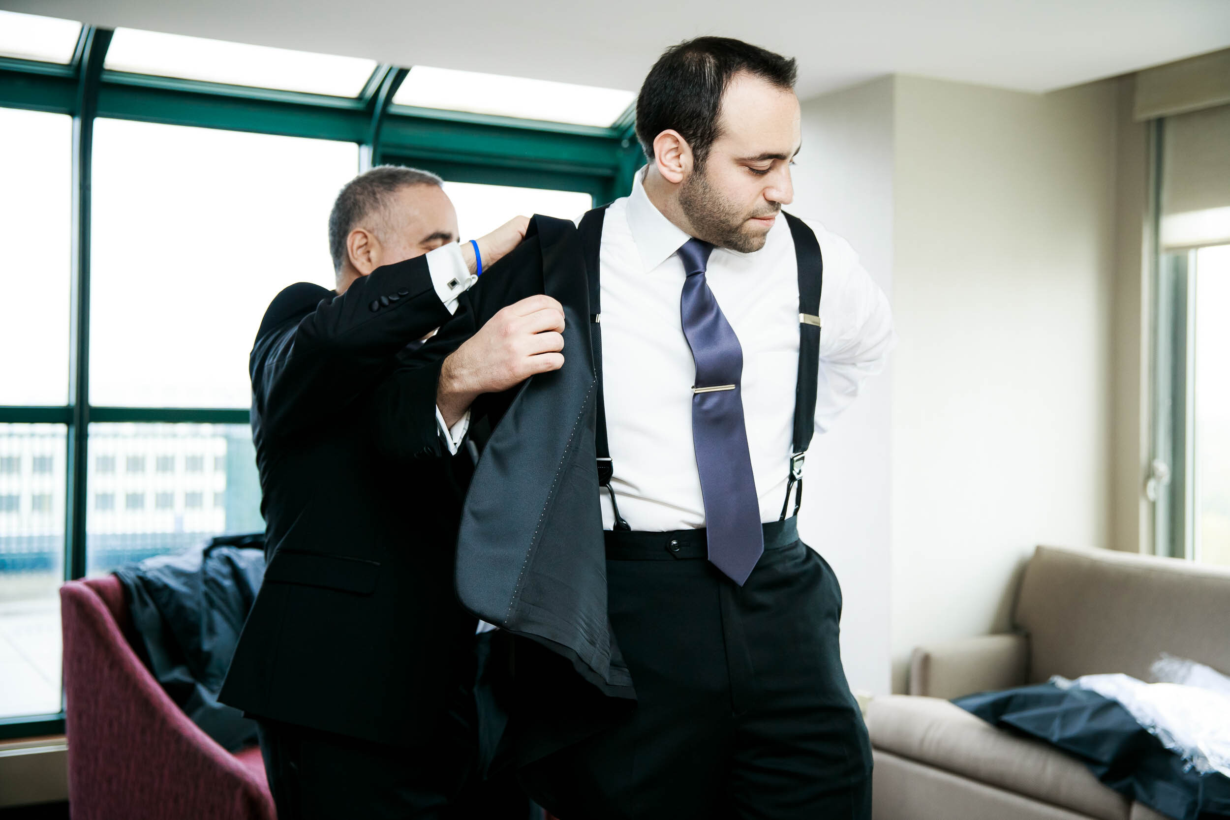 Groom getting ready during a during a Chevy Chase Country Club wedding by J. Brown Photography.