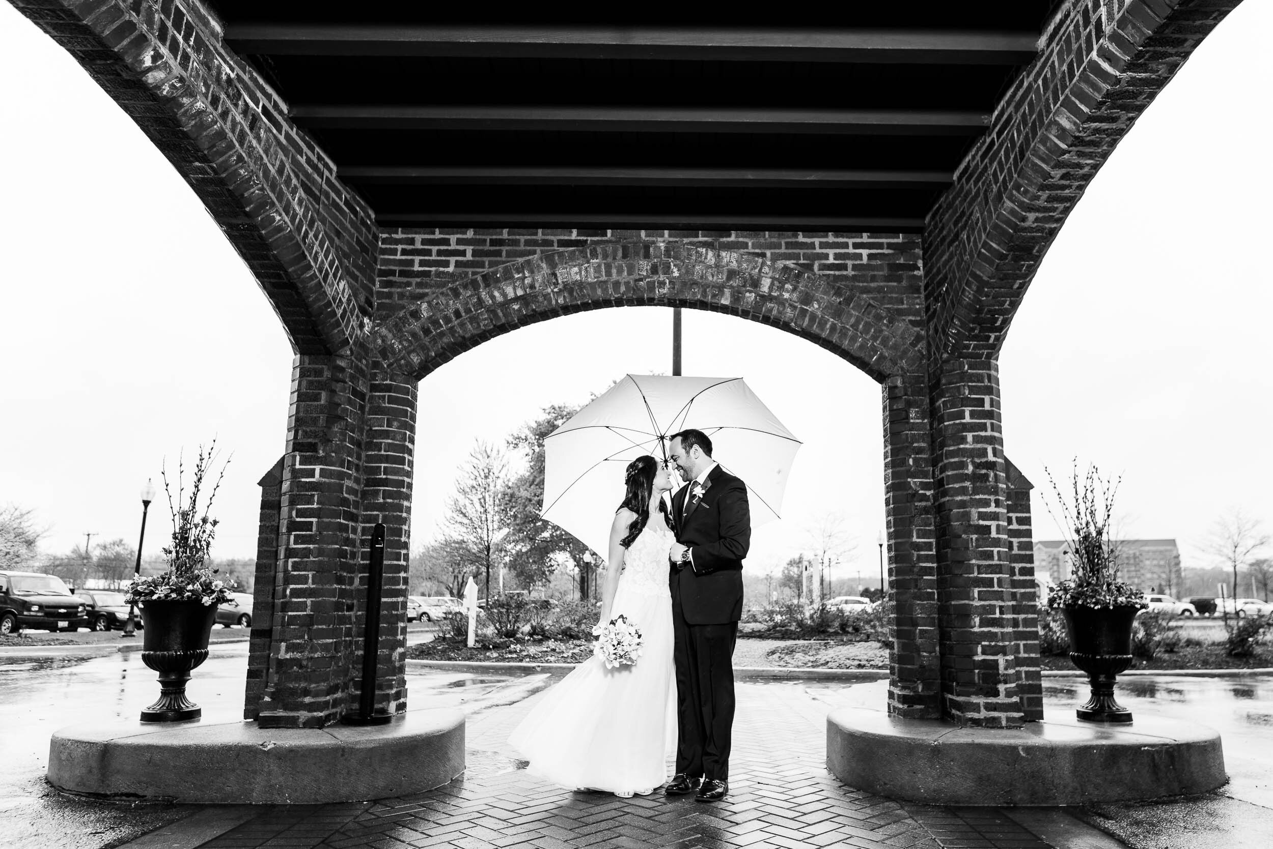 Outdoor rainy day wedding portrait during a Chevy Chase Country Club wedding by J. Brown Photography.