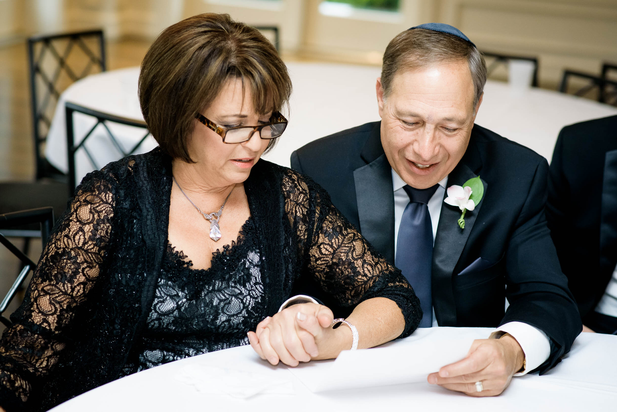 Parents of groom at jewish wedding ketubah signing during a Chevy Chase Country Club wedding by J. Brown Photography.