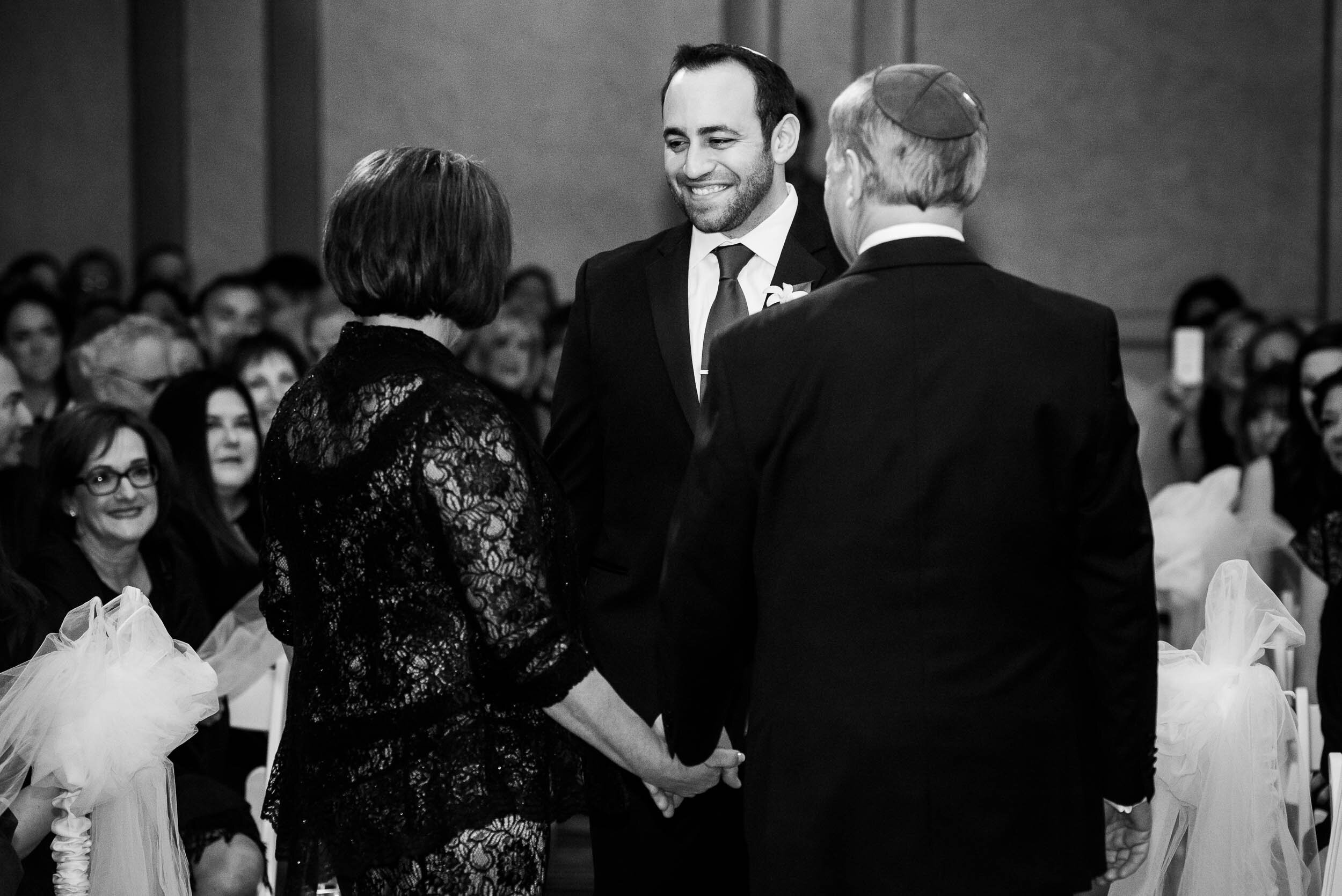 Groom walks down aisle during a jewish Chevy Chase Country Club wedding by J. Brown Photography.