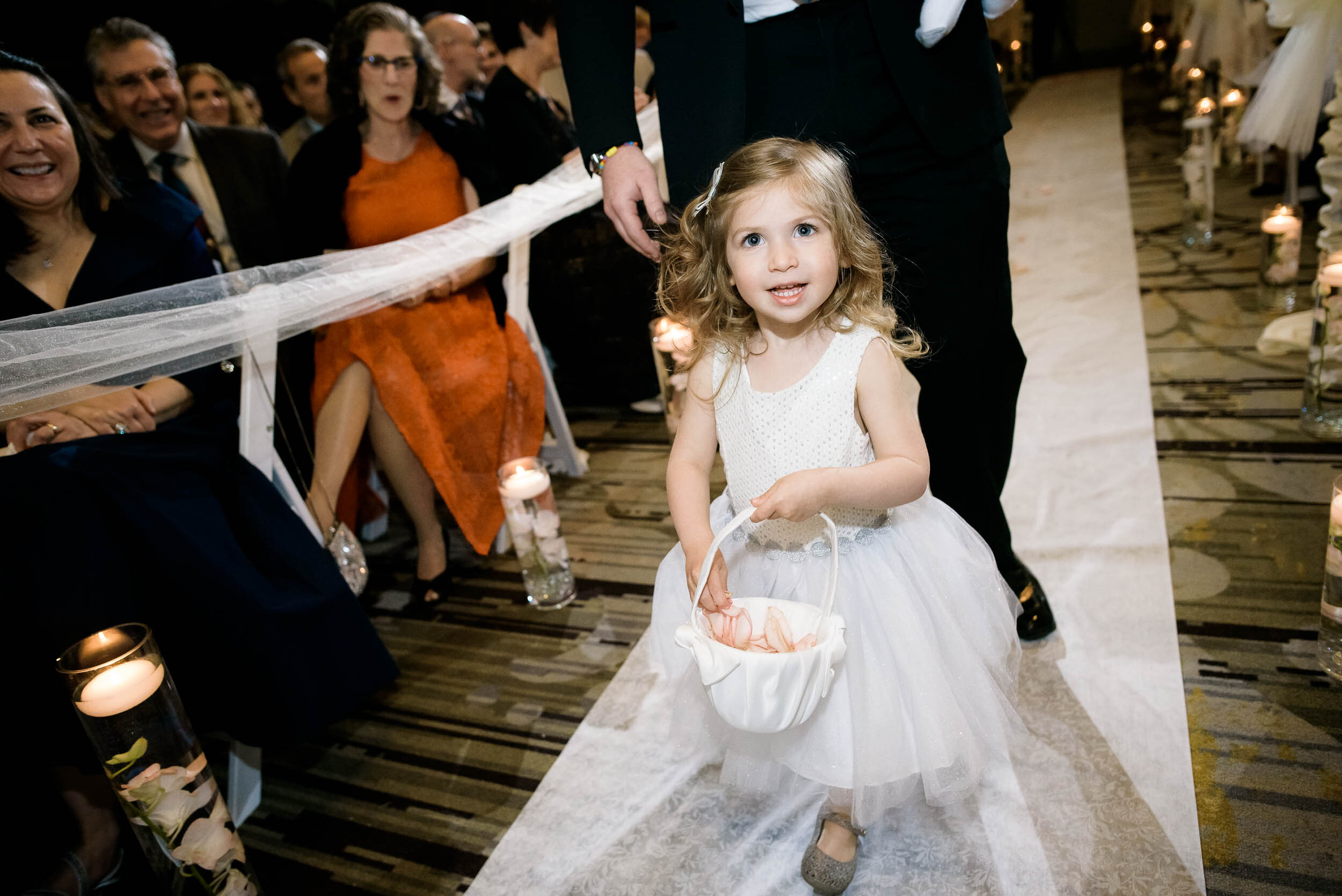 Flower girl walks aisle during a jewish Chevy Chase Country Club wedding by J. Brown Photography.