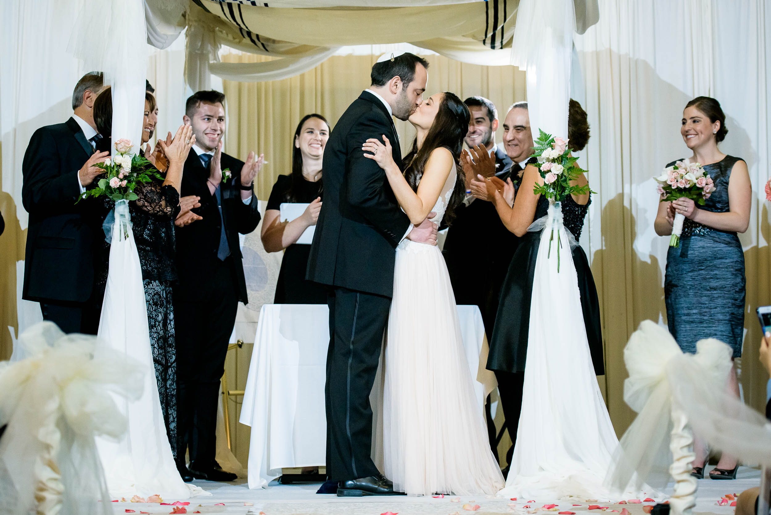 Bride and groom first kiss during a Chevy Chase Country Club jewish wedding by J. Brown Photography.