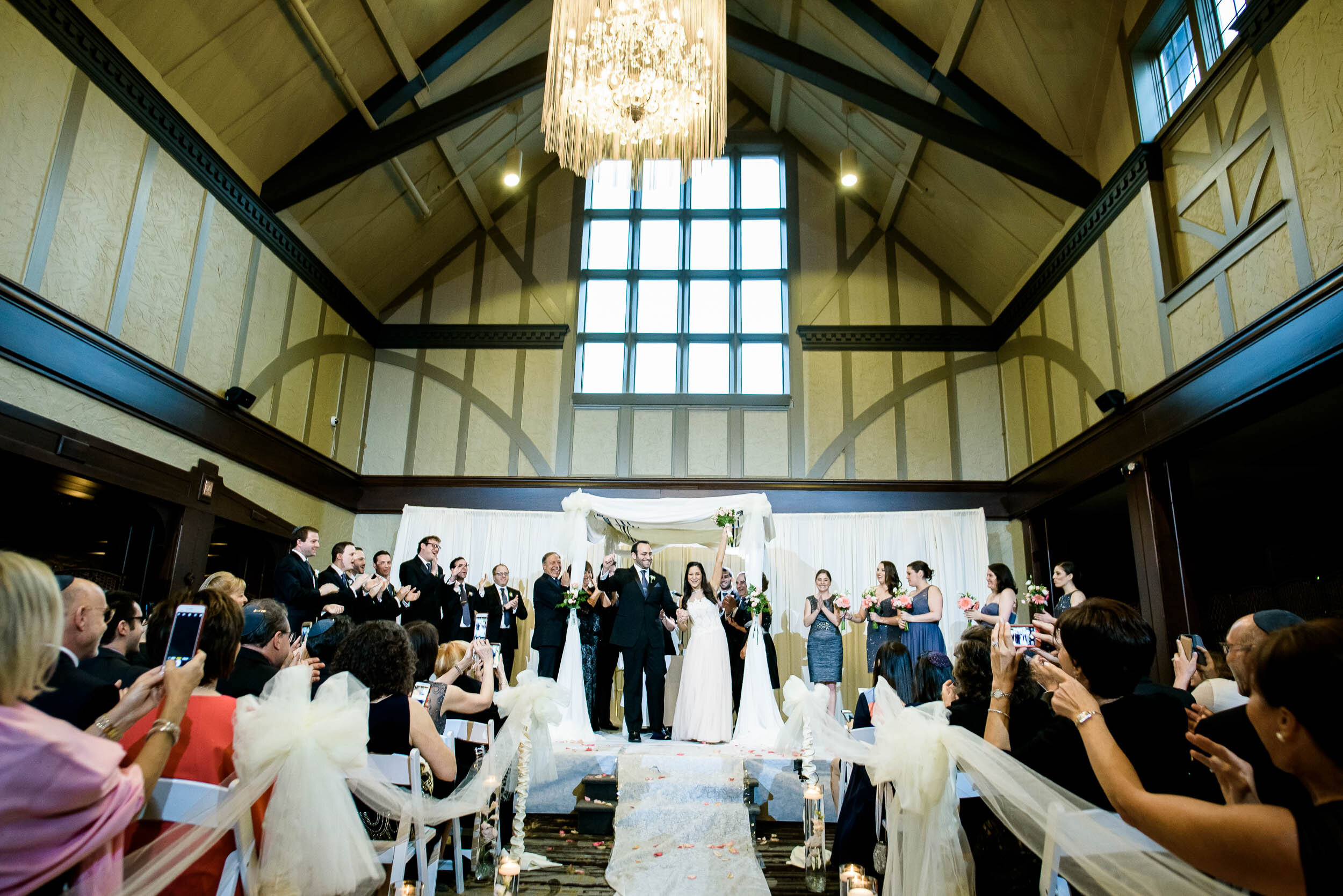 Bride and groom married during a Chevy Chase Country Club jewish wedding by J. Brown Photography.