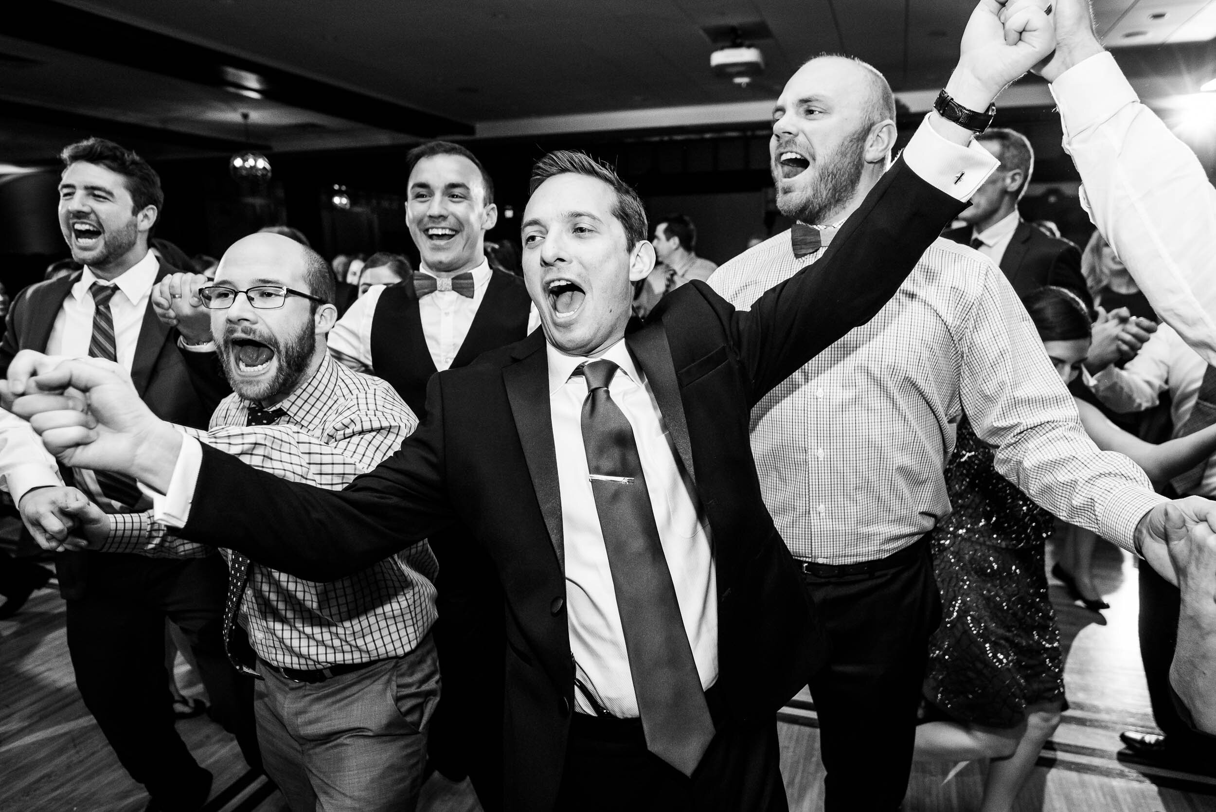 Guests dance around the hora during a Chevy Chase Country Club jewish wedding by J. Brown Photography.