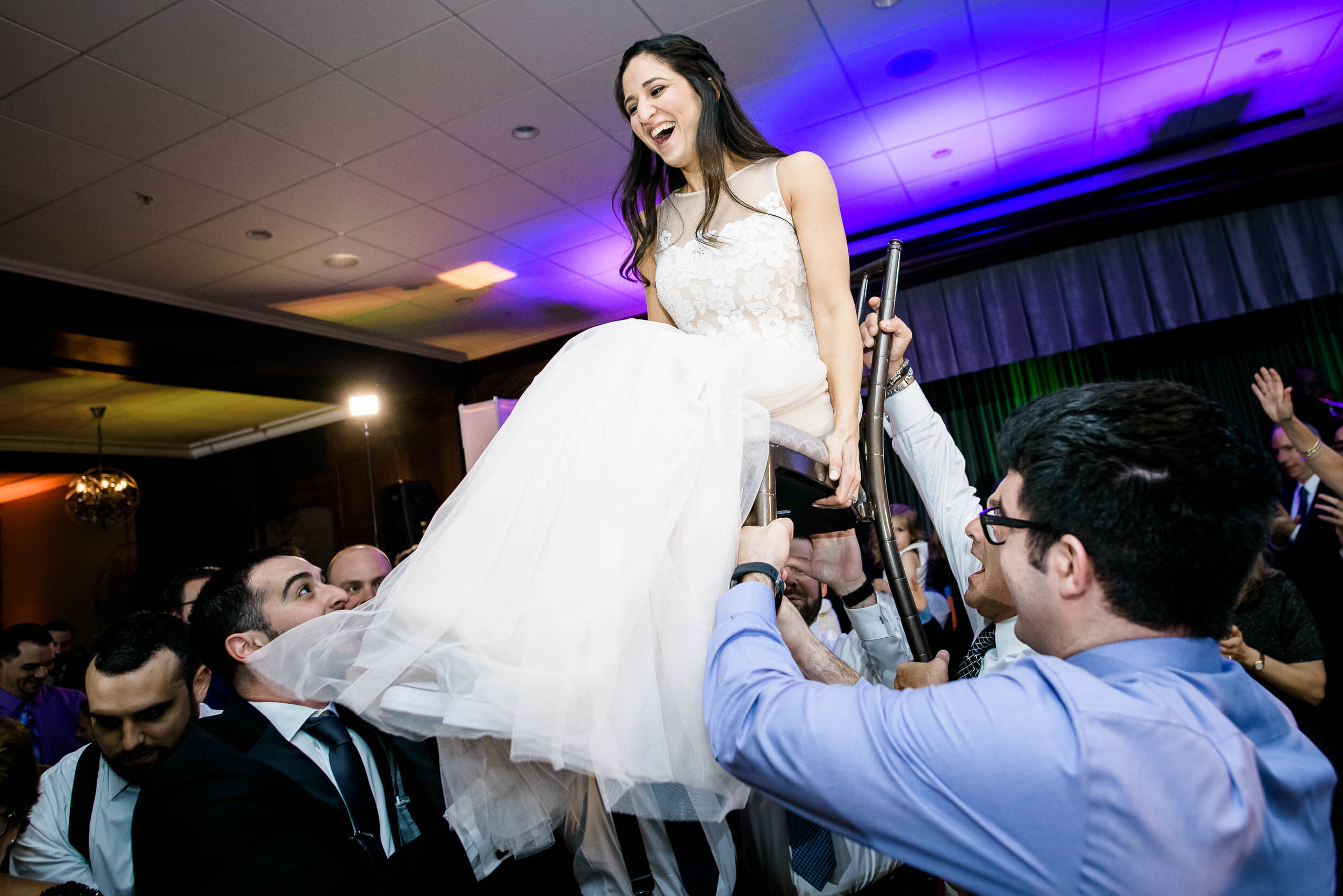Bride raised during the hora during a Chevy Chase Country Club jewish wedding by J. Brown Photography.
