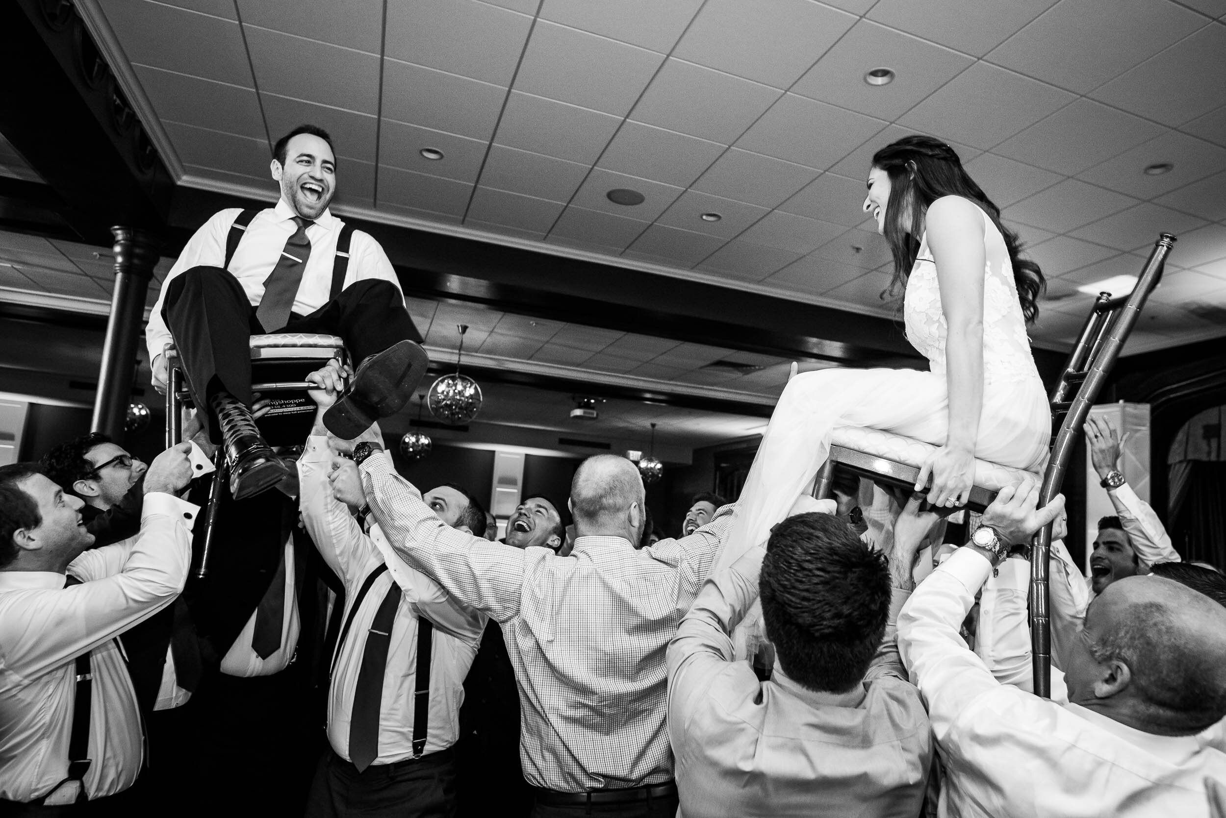 Bride and groom hora dance during a Chevy Chase Country Club jewish wedding by J. Brown Photography.