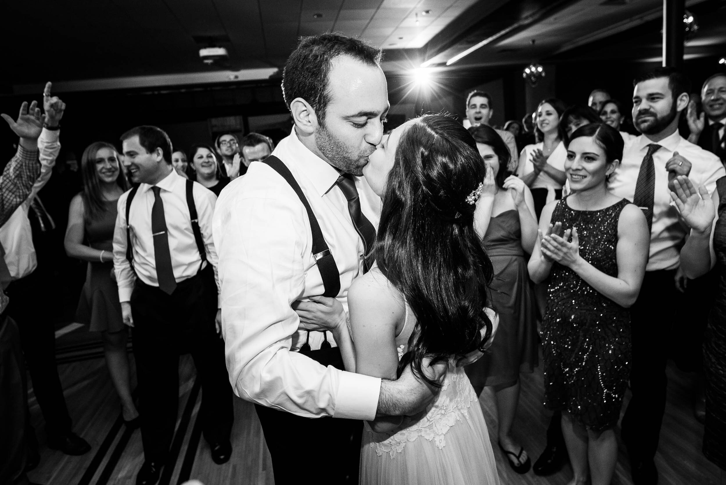 Bride and groom kiss on dance floor during a Chevy Chase Country Club jewish wedding by J. Brown Photography.