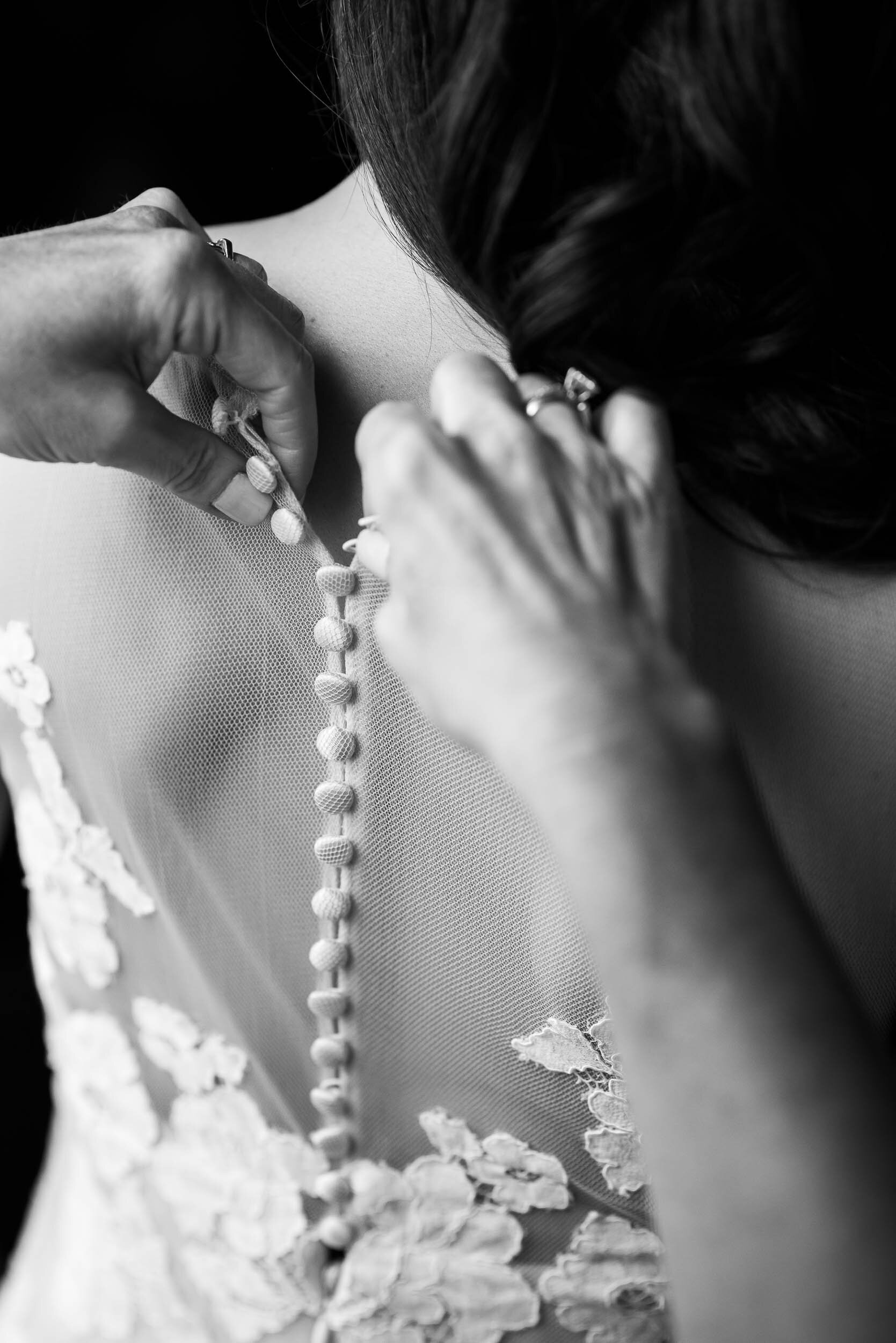 Bride getting dressed during a Chevy Chase Country Club wedding by J. Brown Photography.