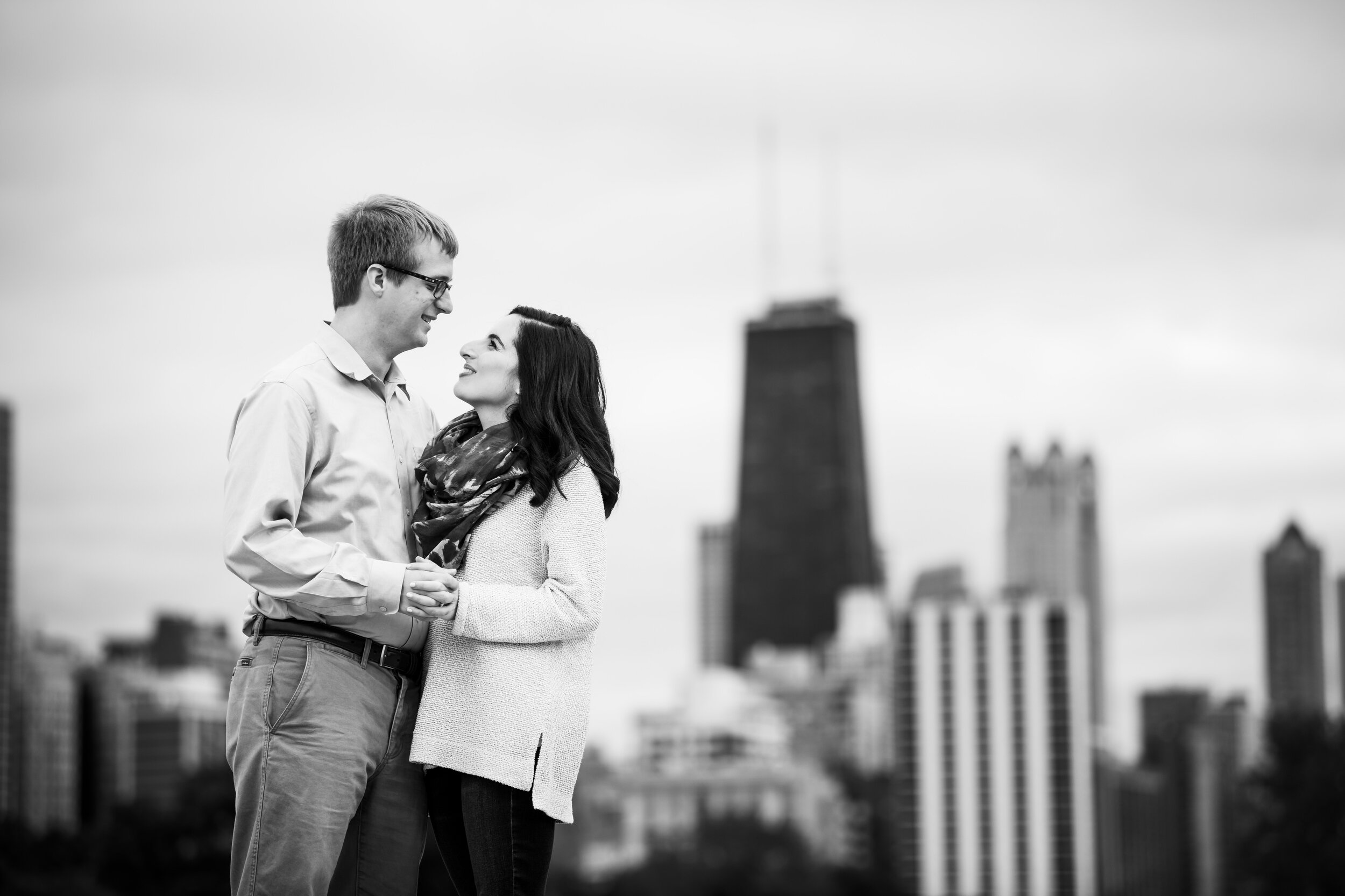 Couple with the skyline during a Chicago engagement session at Lincoln Park.  