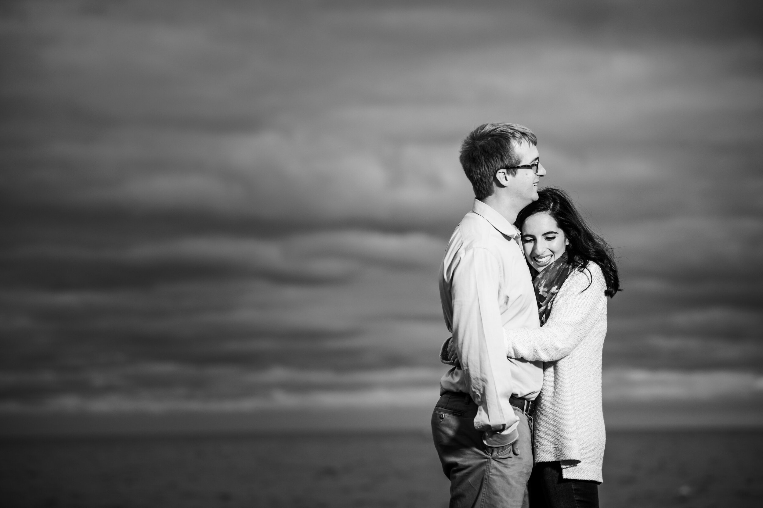 Couple hugs during their Chicago engagement session at North Avenue Beach. 