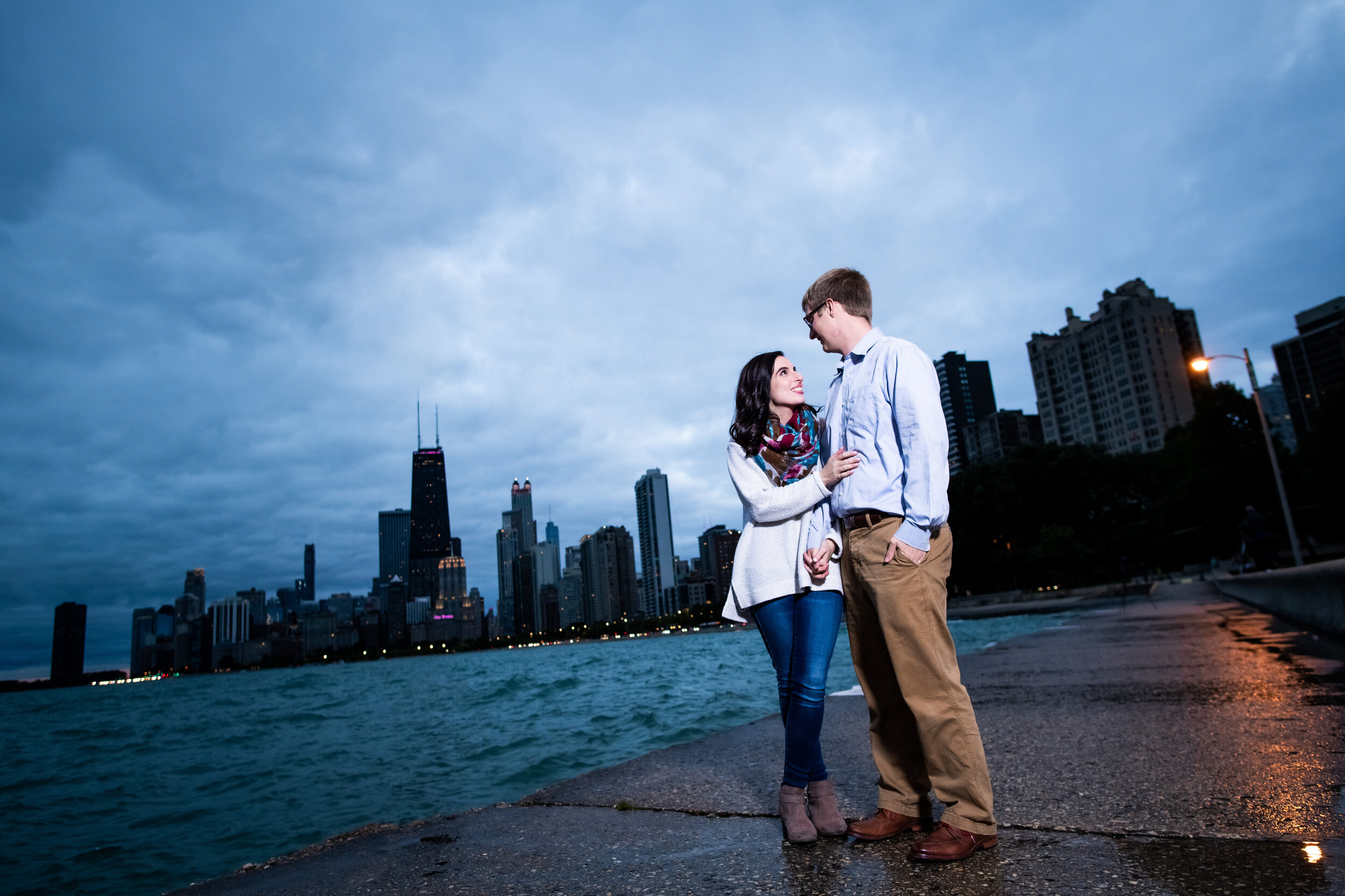 Engagement photo with the Chicago skyline at North Avenue Beach. 