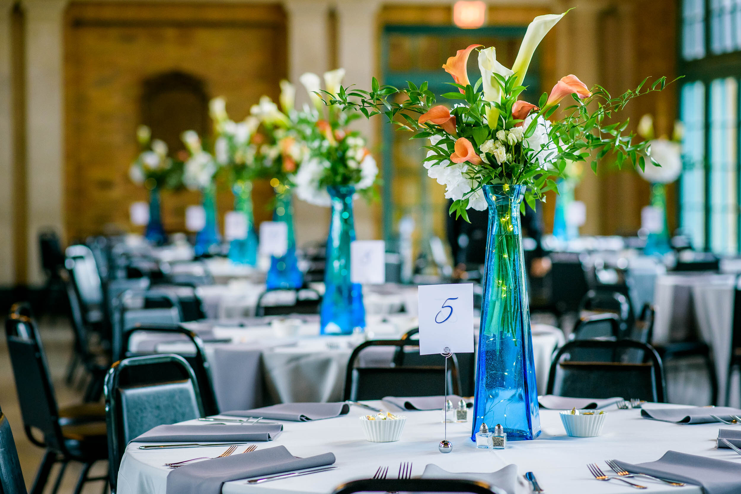 Floral wedding reception detail photo: Columbus Park Refectory Chicago wedding captured by J. Brown Photography.