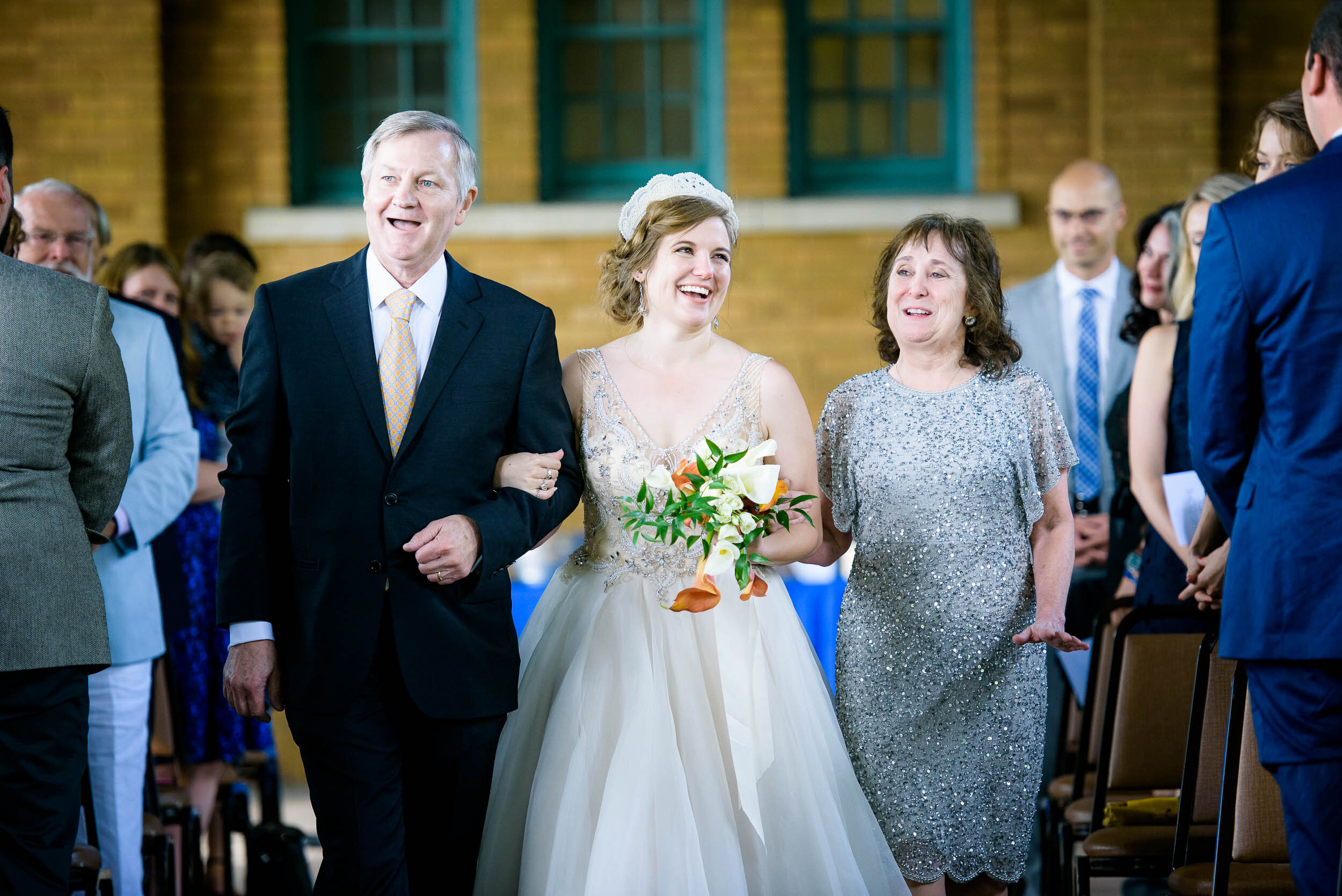 Bride and parents walk down the aisle: Columbus Park Refectory Chicago wedding captured by J. Brown Photography.