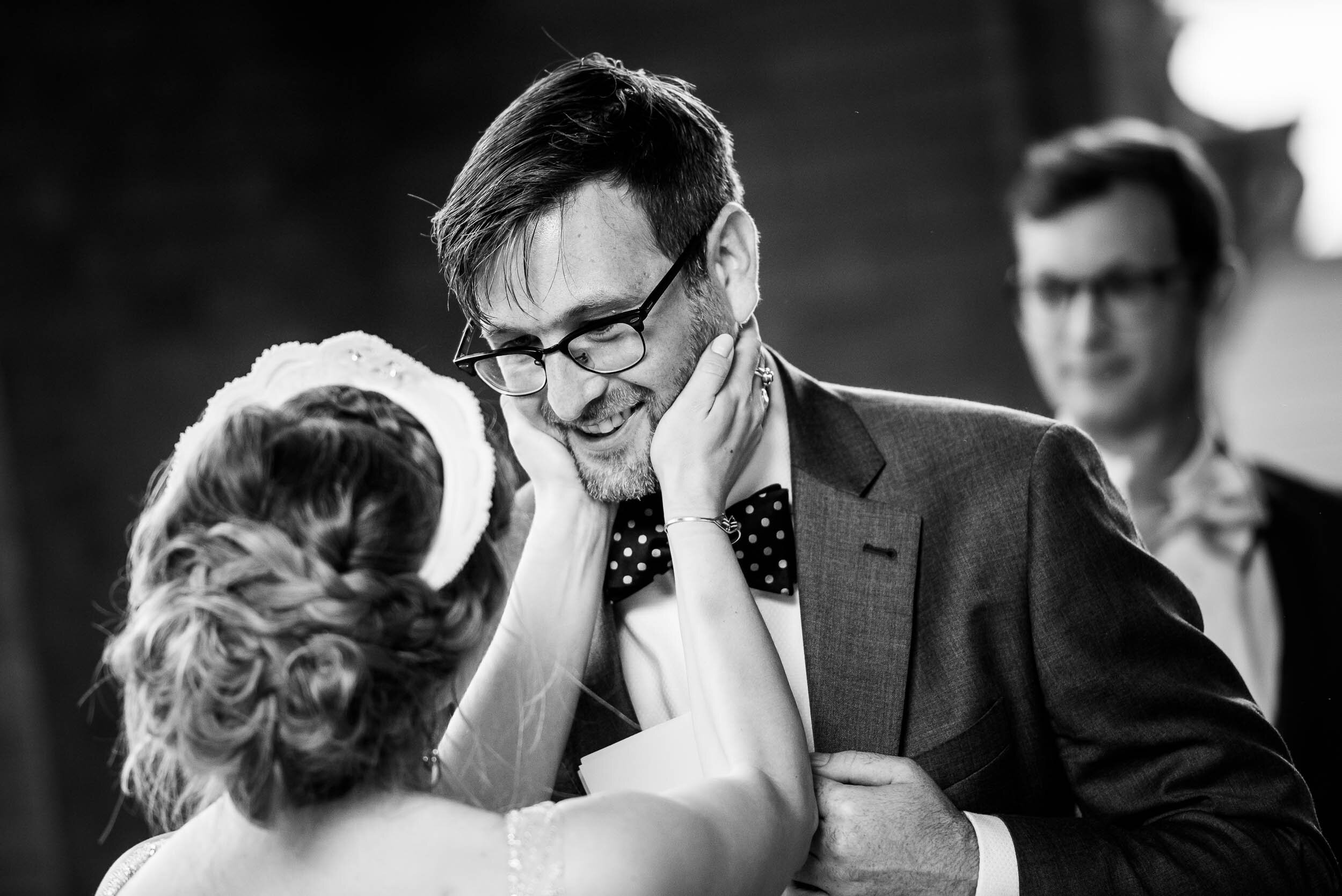 Emotional moment between groom and bride during their wedding ceremony: Columbus Park Refectory Chicago wedding captured by J. Brown Photography.