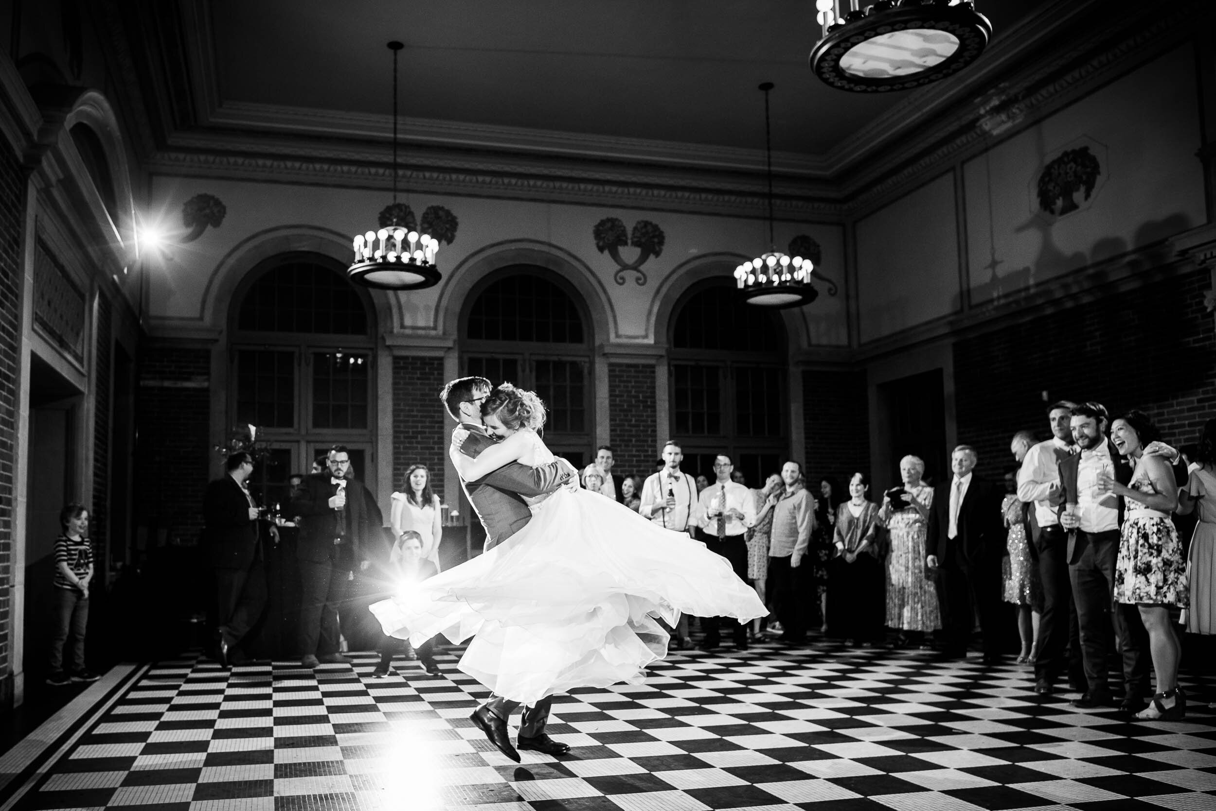 Groom spins the bride during their first dance: Columbus Park Refectory Chicago wedding captured by J. Brown Photography.