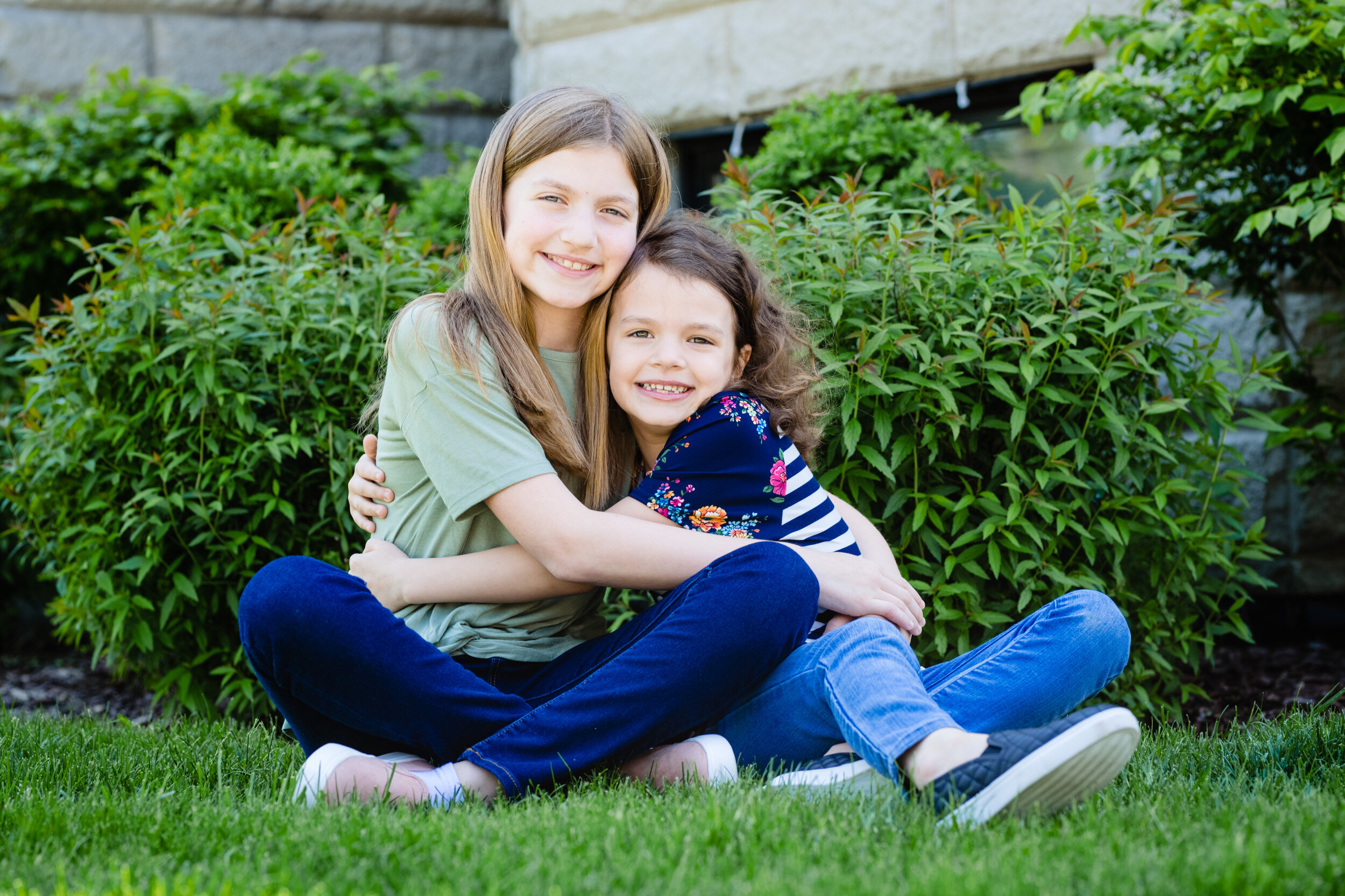 Candid photo of daughters: family portrait session photographed by J. Brown Photography.