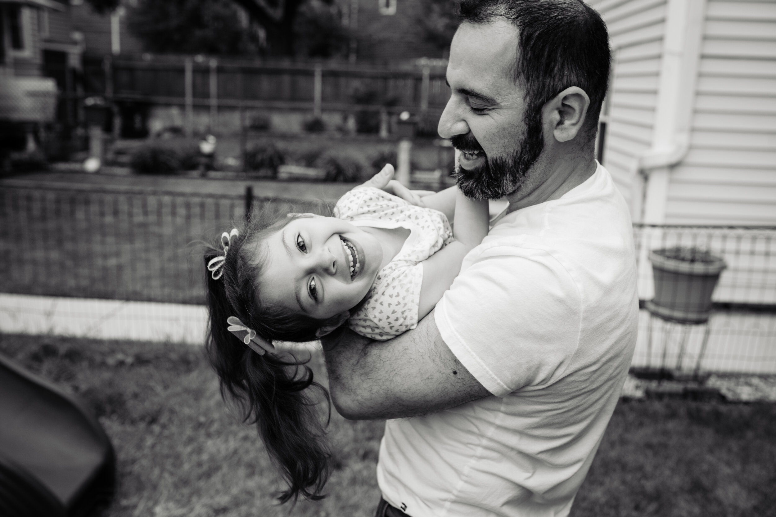 Fun candid photo of father and daughter: family portrait session photographed by J. Brown Photography.