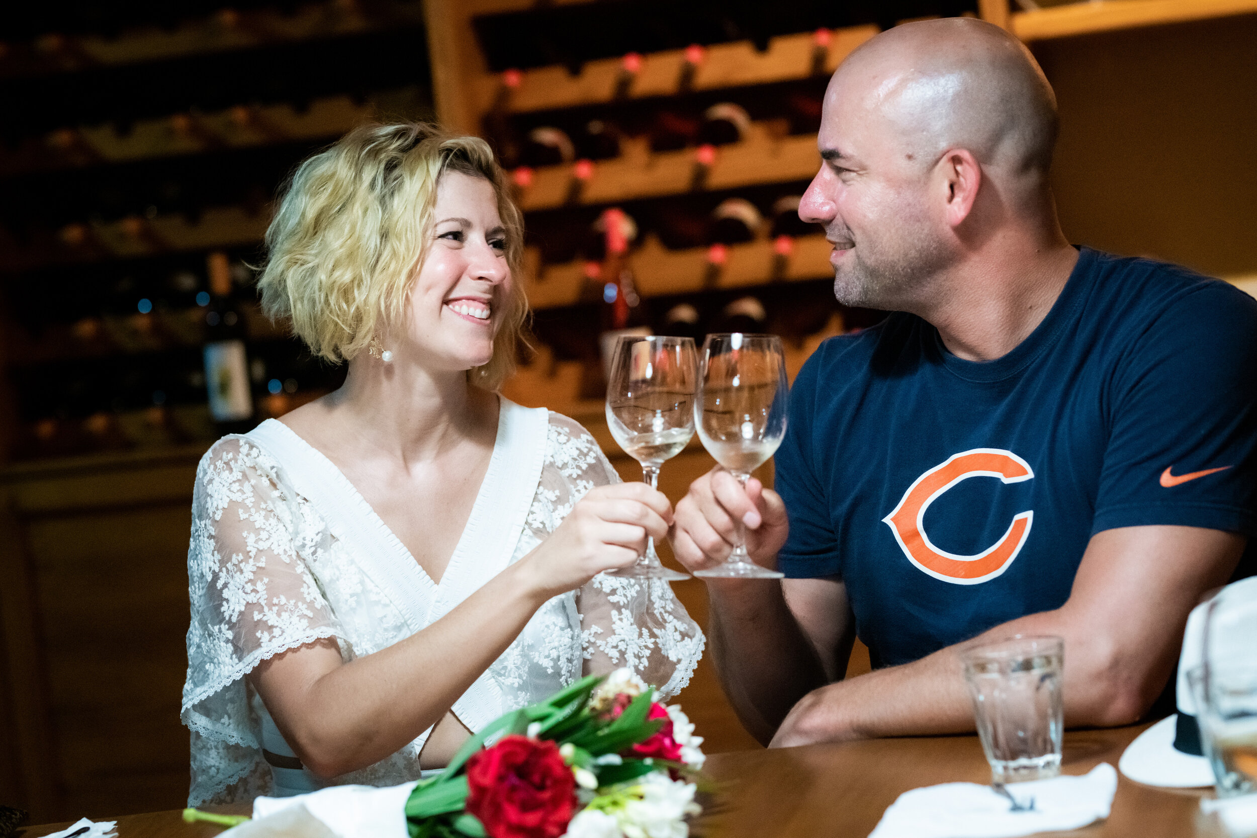 Bride and groom toast during a wine tasting at Patistis Vineyards: photo of destination wedding in Greece by J. Brown Photography.