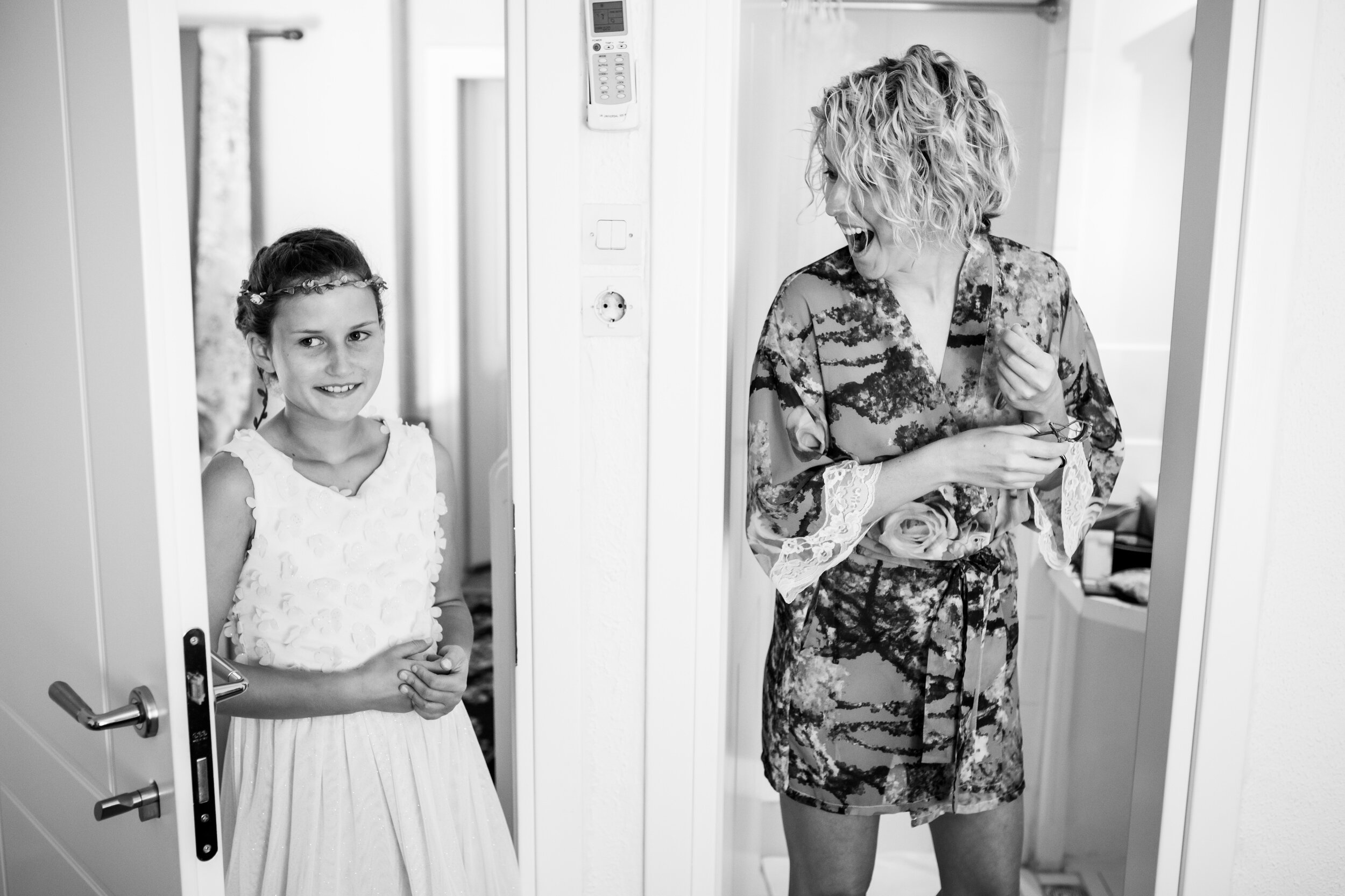 Bride reacts to arrival of the flower girl:  destination wedding photo at the Lost Unicorn Hotel, Tsagarada, Greece by J. Brown Photography.