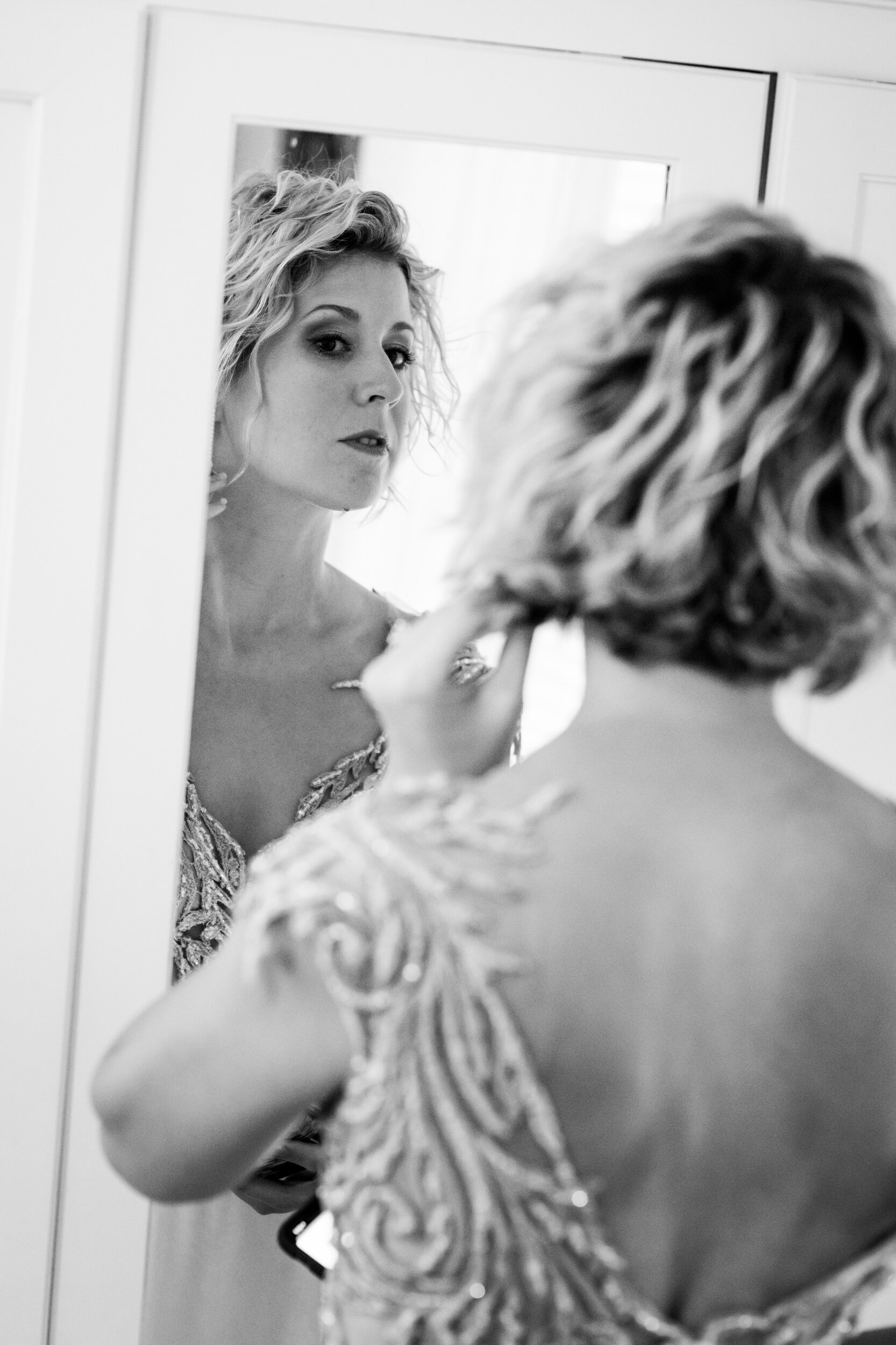 Black and white photo of bride getting ready:  destination wedding photo at the Lost Unicorn Hotel, Tsagarada, Greece by J. Brown Photography.