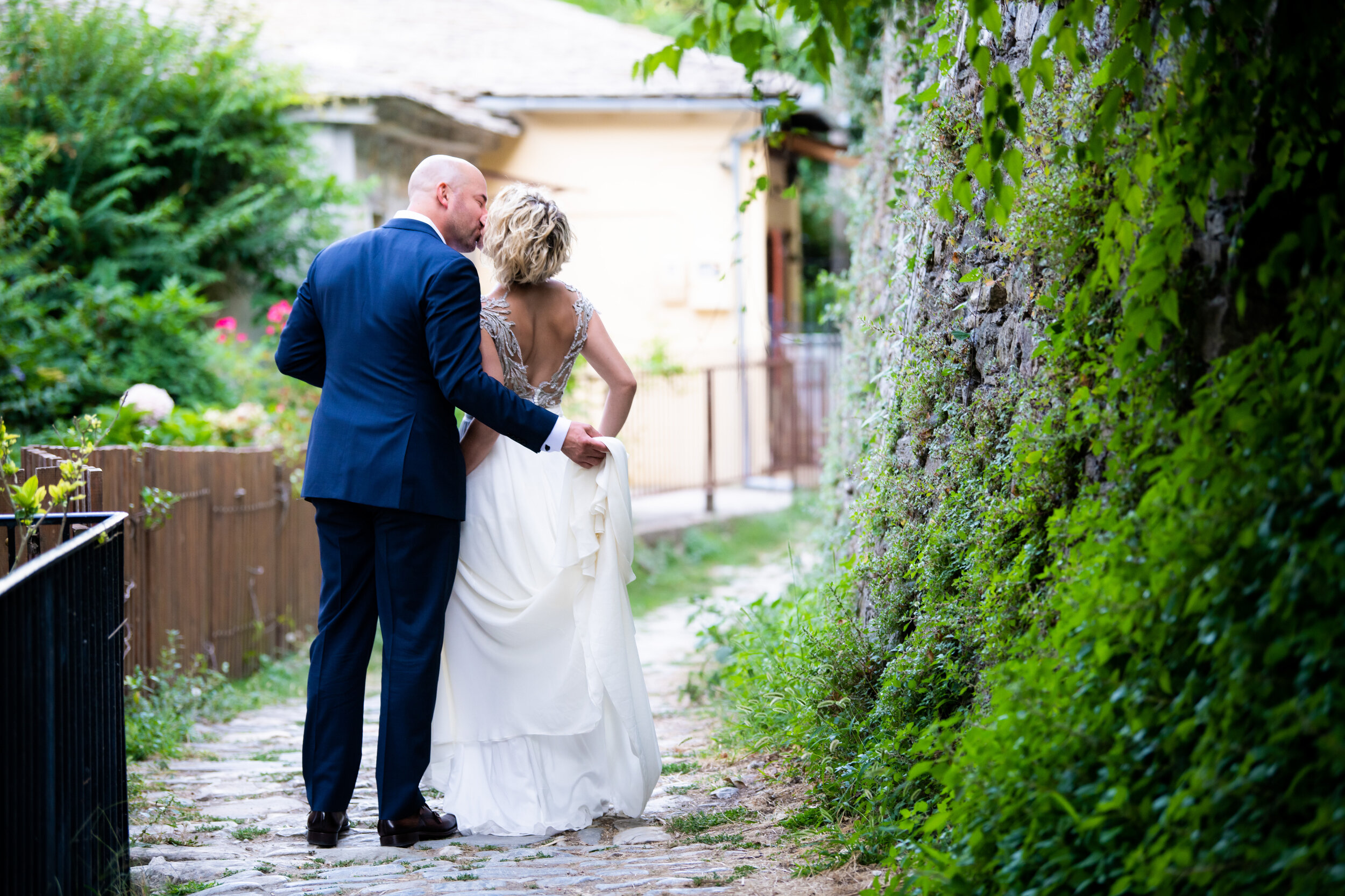 Candid wedding day portrait of the bride and groom:  destination wedding photo at the Lost Unicorn Hotel, Tsagarada, Greece by J. Brown Photography.