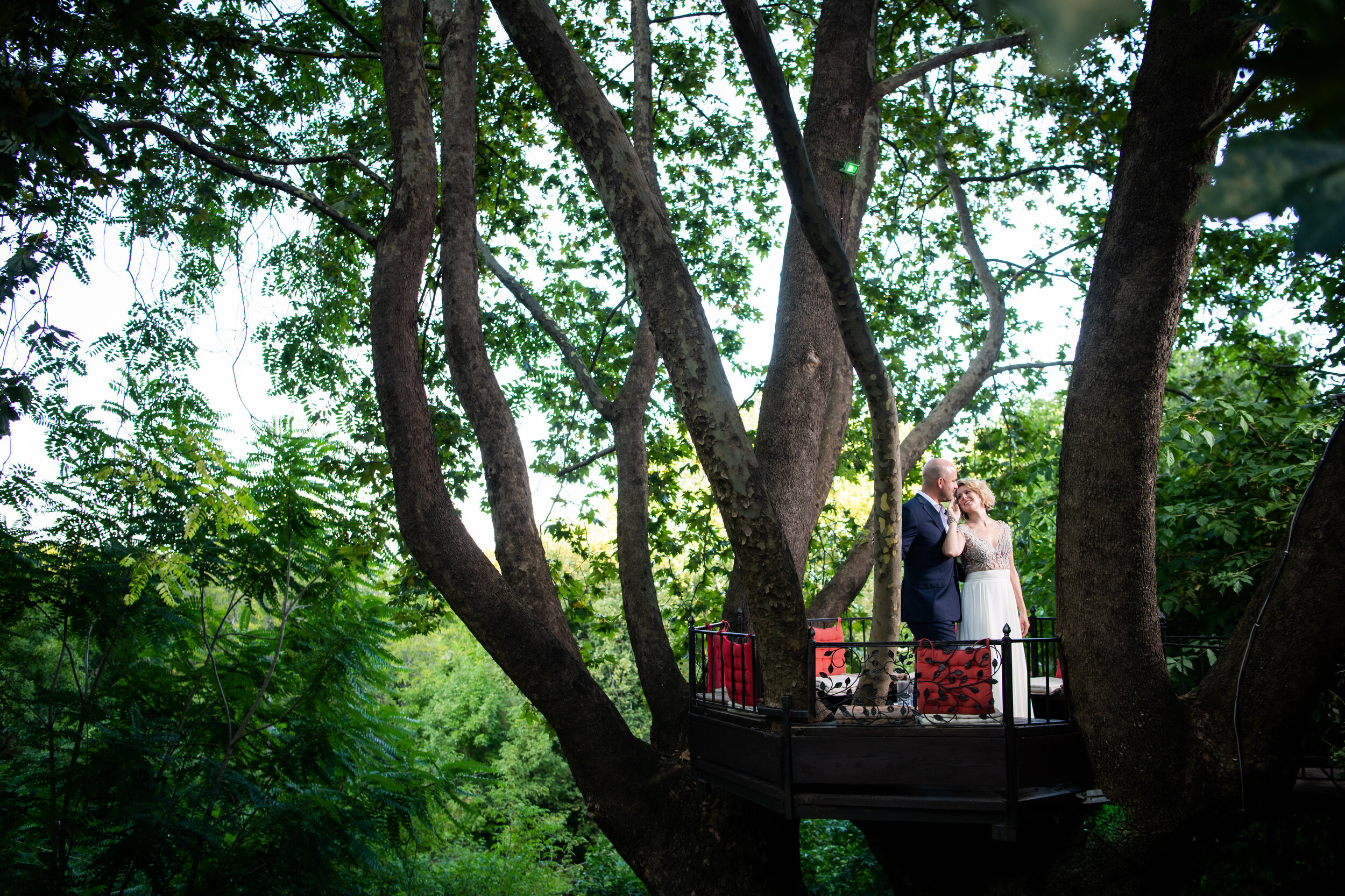 Creative edgy portrait of the bride and groom in a tree house:  destination wedding photo at the Lost Unicorn Hotel, Tsagarada, Greece by J. Brown Photography.
